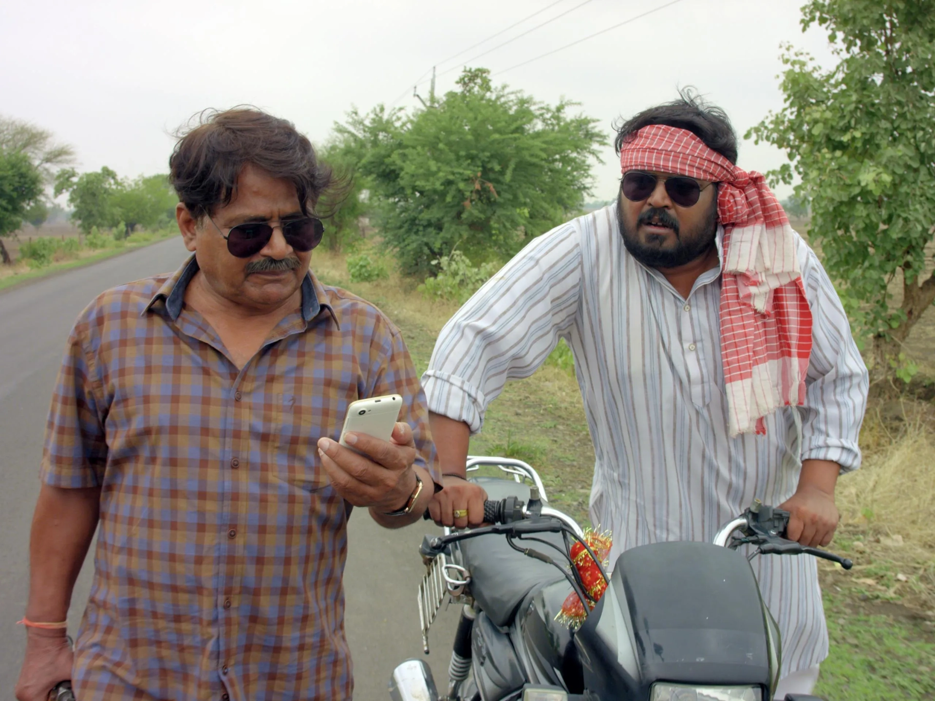 Raghubir Yadav and Faisal Malik in Panchayat (2020)