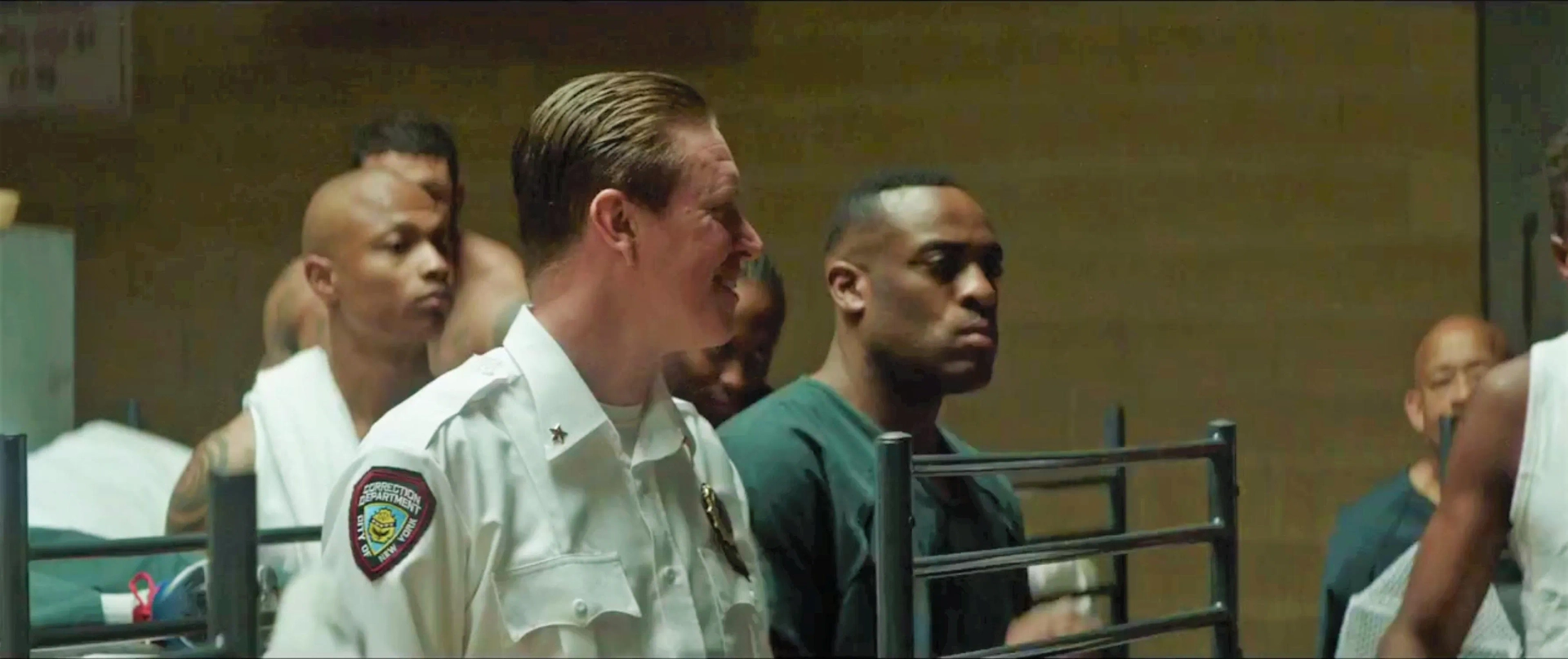 Screen Shot from the 2019 Movie 'The Informer'. Kenny-Lee Mbanefo playing the role of an Prison Inmate staring down Pete Koslow played by Joel Kinnaman