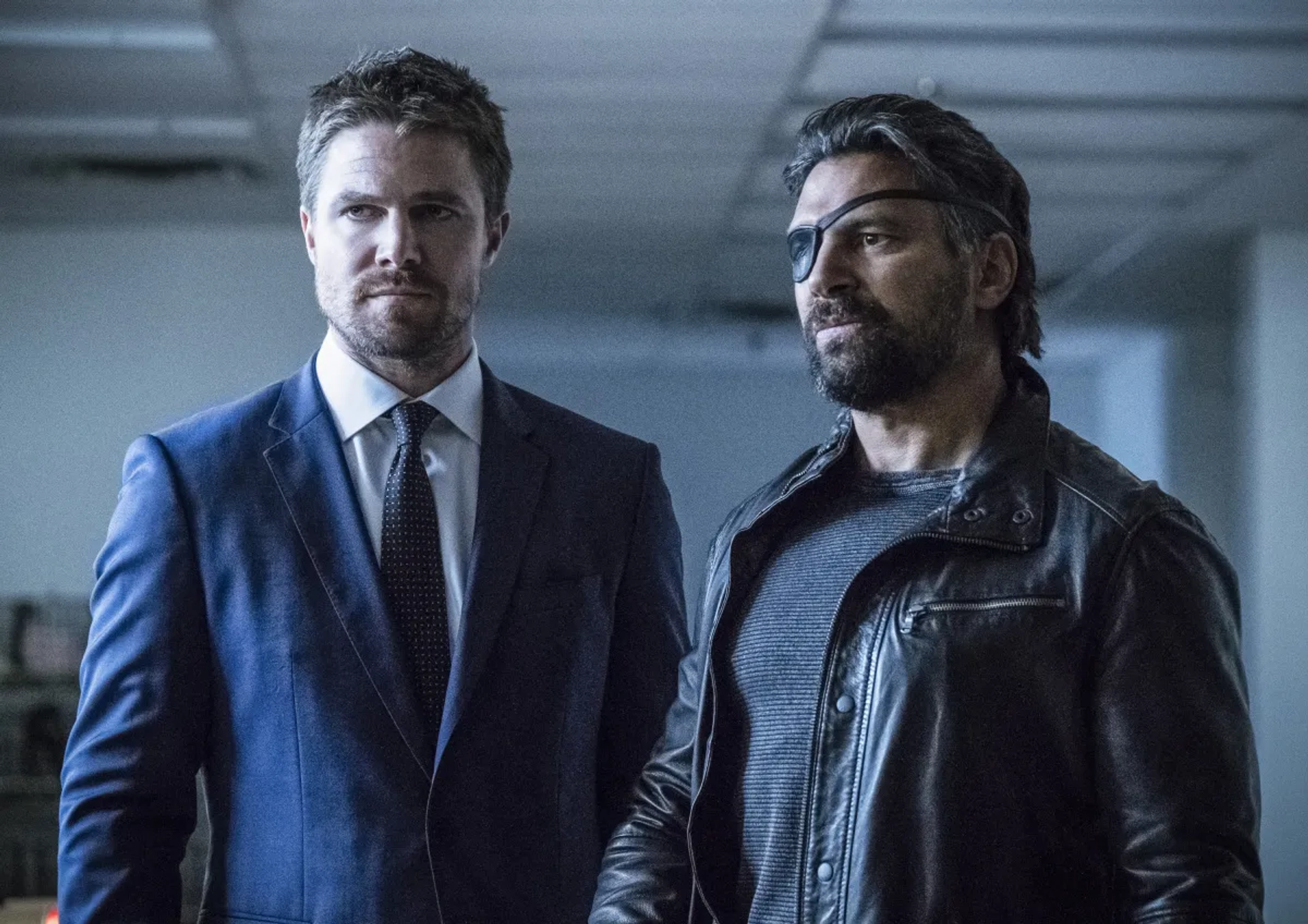 Manu Bennett and Stephen Amell in Arrow (2012)