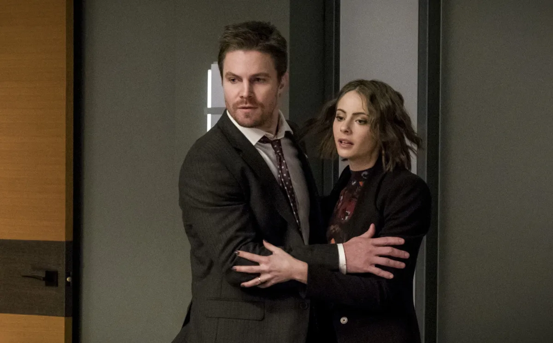 Willa Holland and Stephen Amell in Arrow (2012)