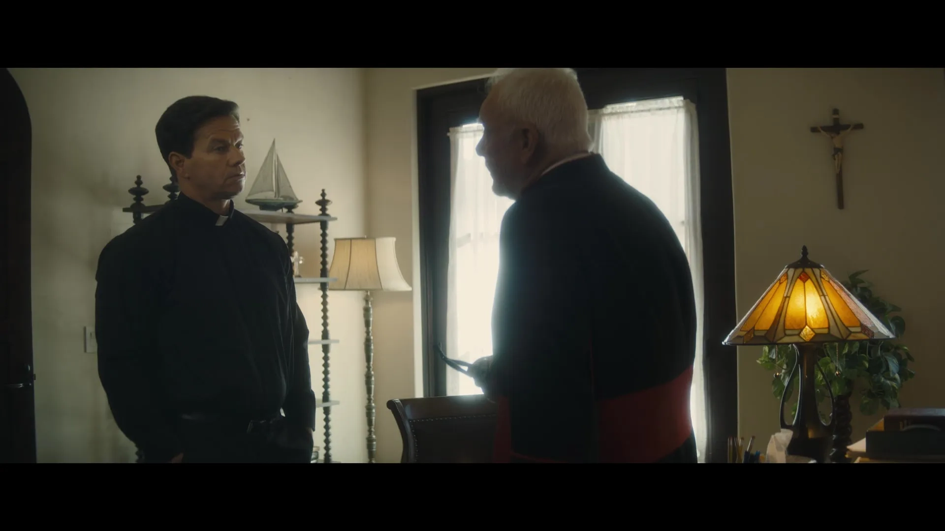 Mark Wahlberg and Malcolm McDowell in Father Stu (2022)