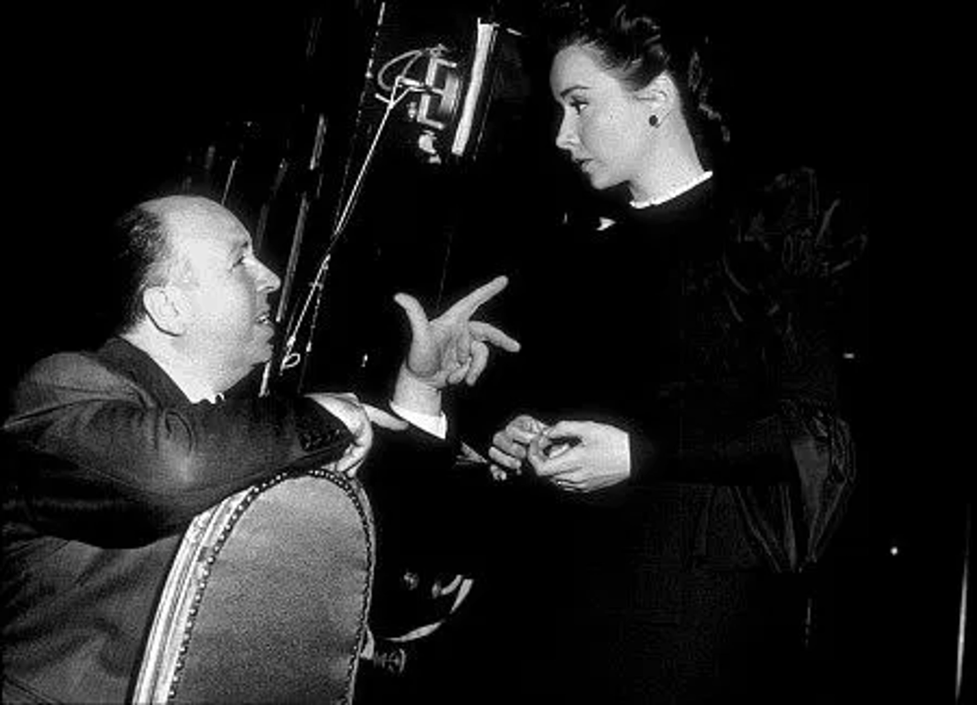 Alfred Hitchcock on the set of "Rope" with Joan Chandler, 1948.