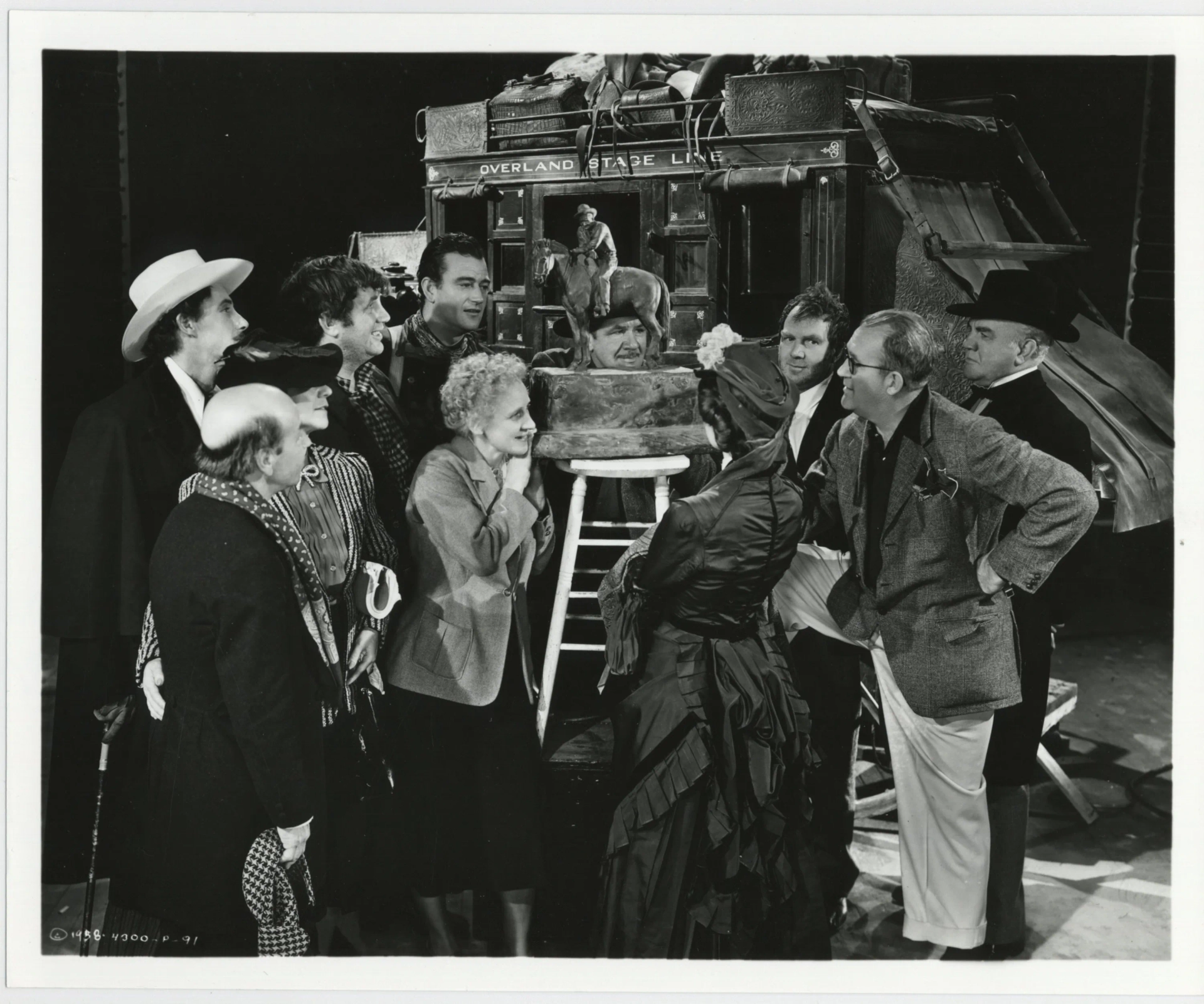 John Wayne, John Ford, John Carradine, George Bancroft, Nora Cecil, Berton Churchill, Andy Devine, Donald Meek, Thomas Mitchell, and Louise Platt in Stagecoach (1939)