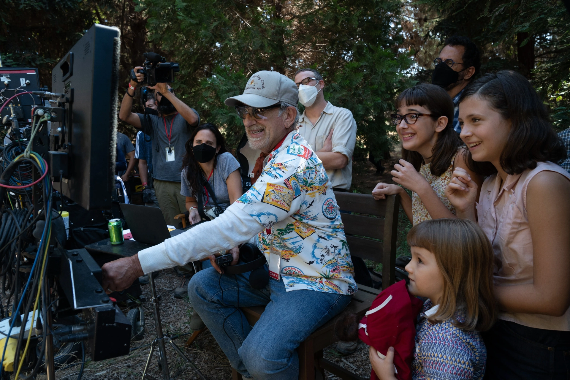 (from left background) Producer Kristie Macosko Kriger, co-writer/producer/director Steven Spielberg, Seth Rogen, Julia Butters, co-writer/producer Tony Kushner, Keeley Karsten and Sophia Kopera on the set of The Fabelmans