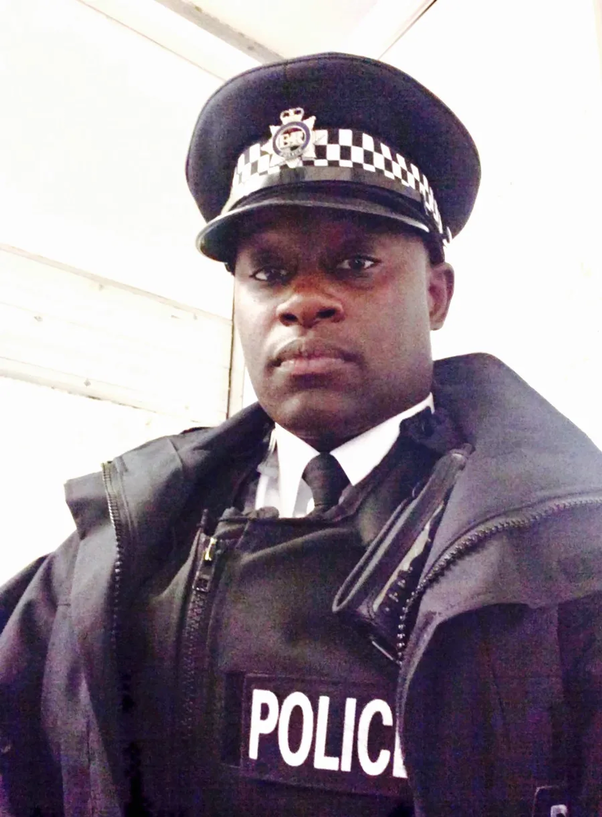 Behind the scenes image of Dywayne Thomas as a Royalty and Specialist Protection Police Officer, London, England.