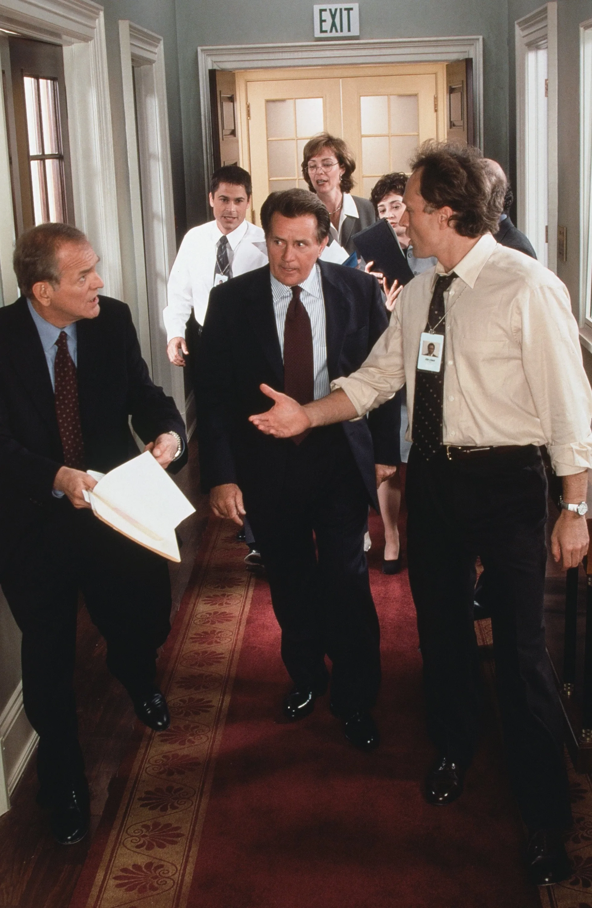 Rob Lowe, Martin Sheen, Allison Janney, Moira Kelly, John Spencer, Bradley Whitford, Kevin Foley, and Mandy Hampton in The West Wing (1999)