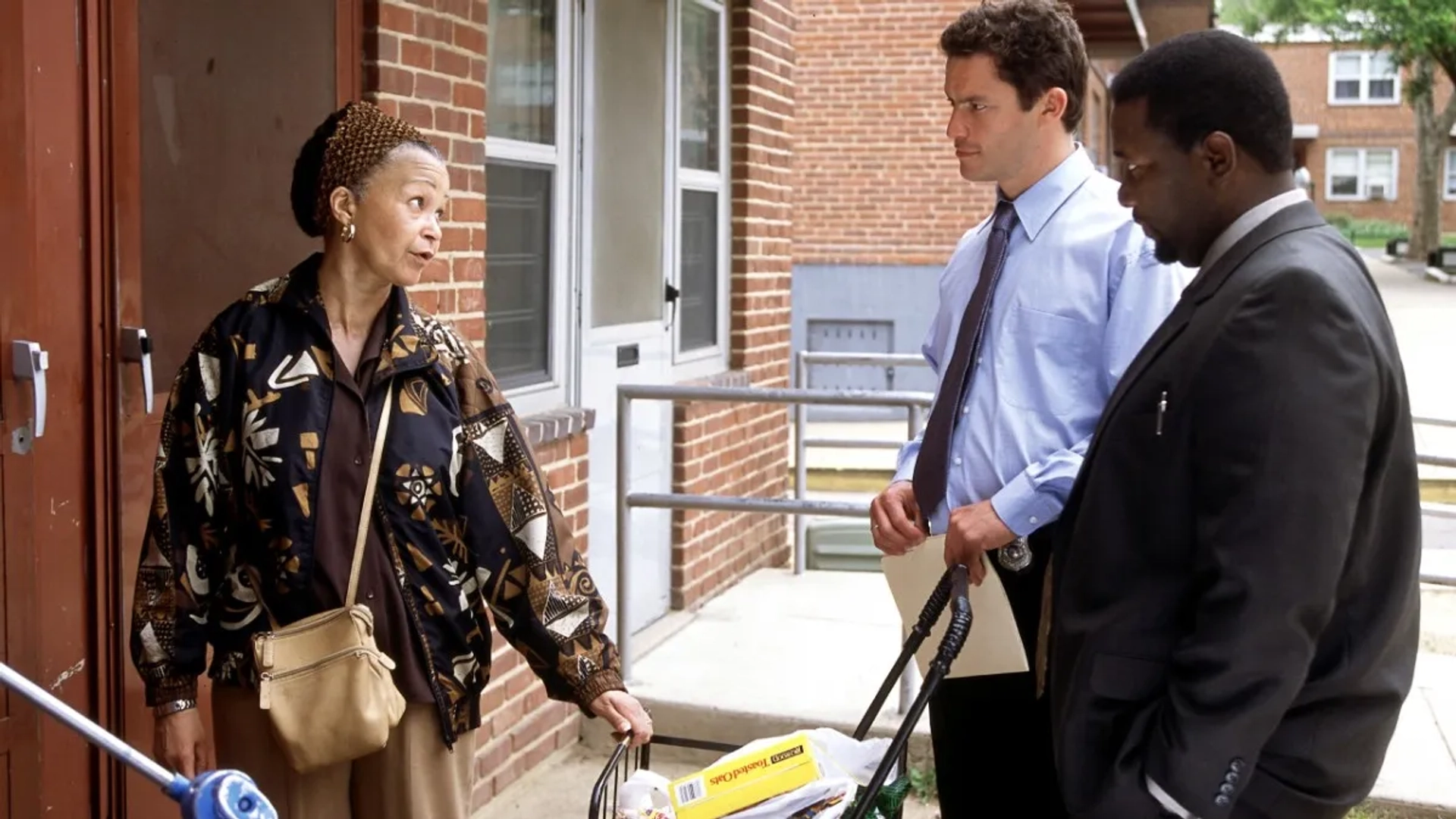 Lizan Mitchell, Wendell Pierce, and Dominic West in The Wire (2002)