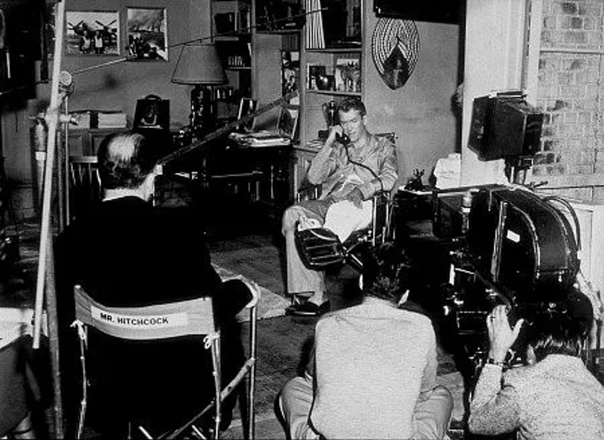 "Rear Window," James Stewart on the set while Alfred Hitchcock directs. 1954 Paramount