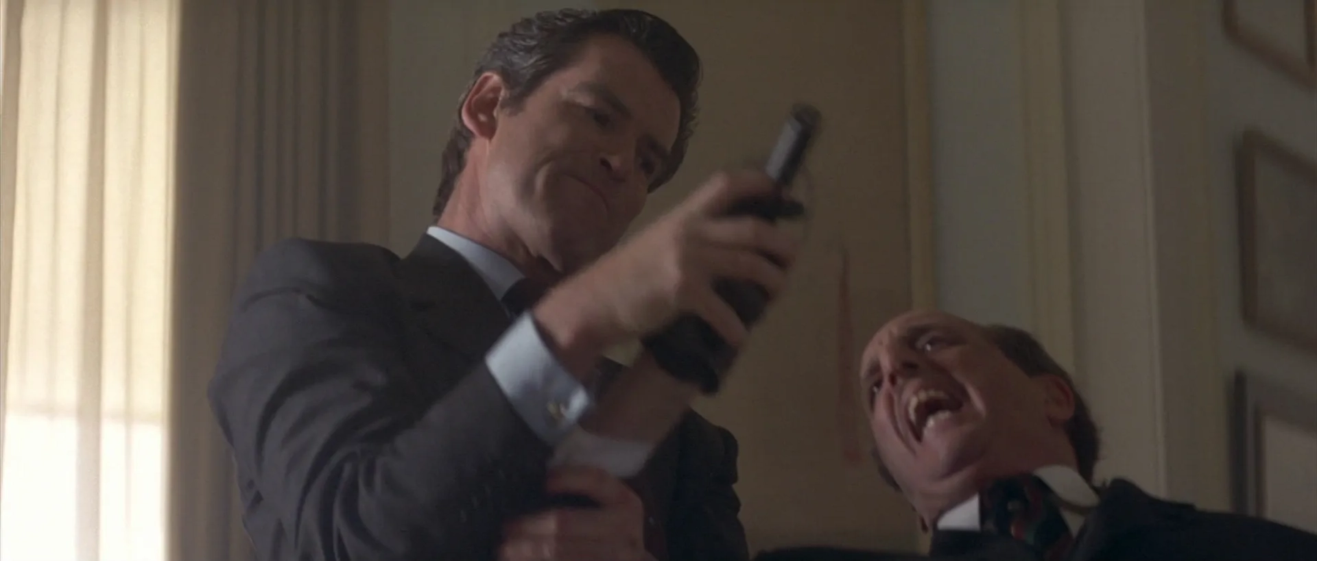 Pierce Brosnan and Vincent Schiavelli in Tomorrow Never Dies (1997)