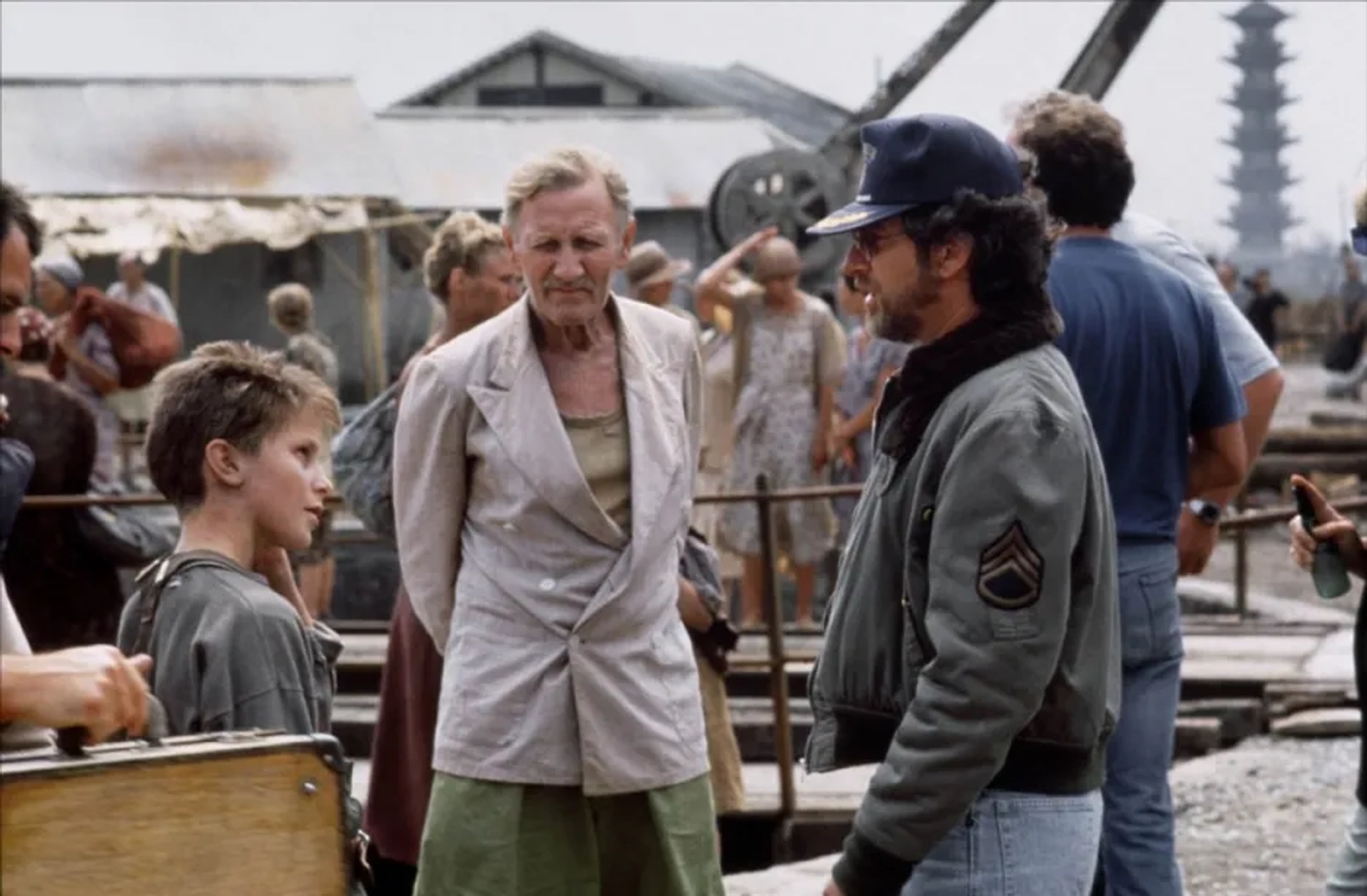 Steven Spielberg, Christian Bale, and Leslie Phillips in Empire of the Sun (1987)