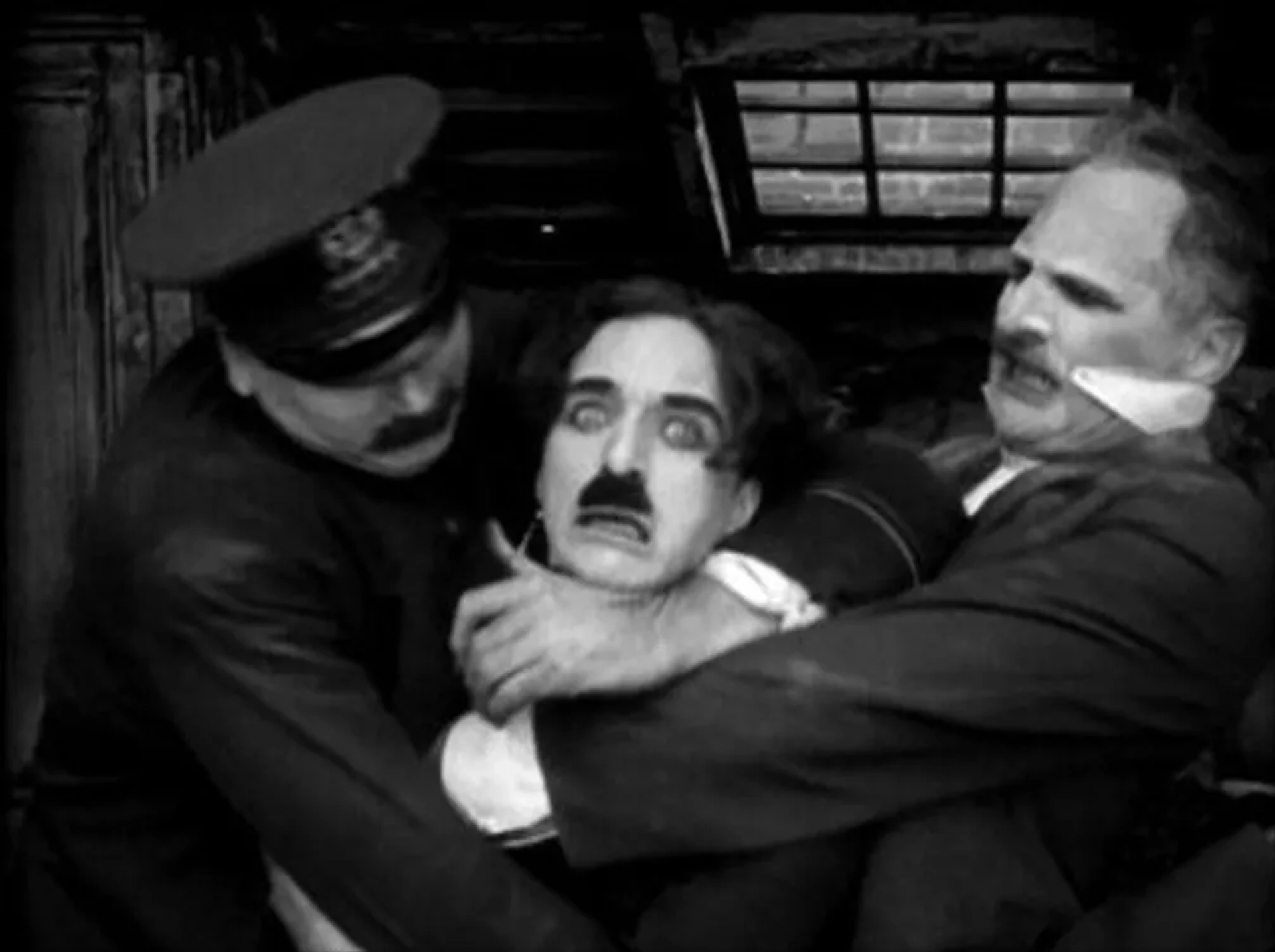 Charles Chaplin, Frank Campeau, and Tom Wilson in The Kid (1921)