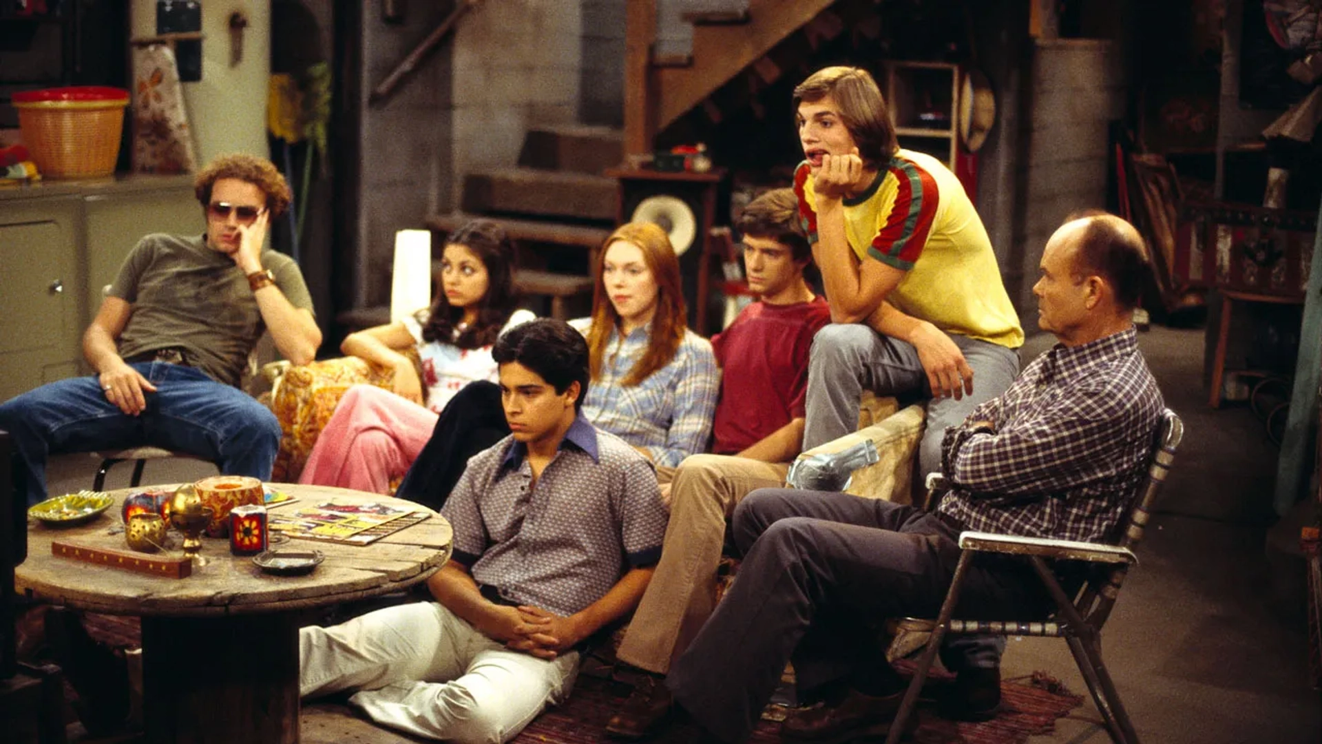 Kurtwood Smith, Mila Kunis, Ashton Kutcher, Danny Masterson, Wilmer Valderrama, Topher Grace, and Laura Prepon in That '70s Show (1998)