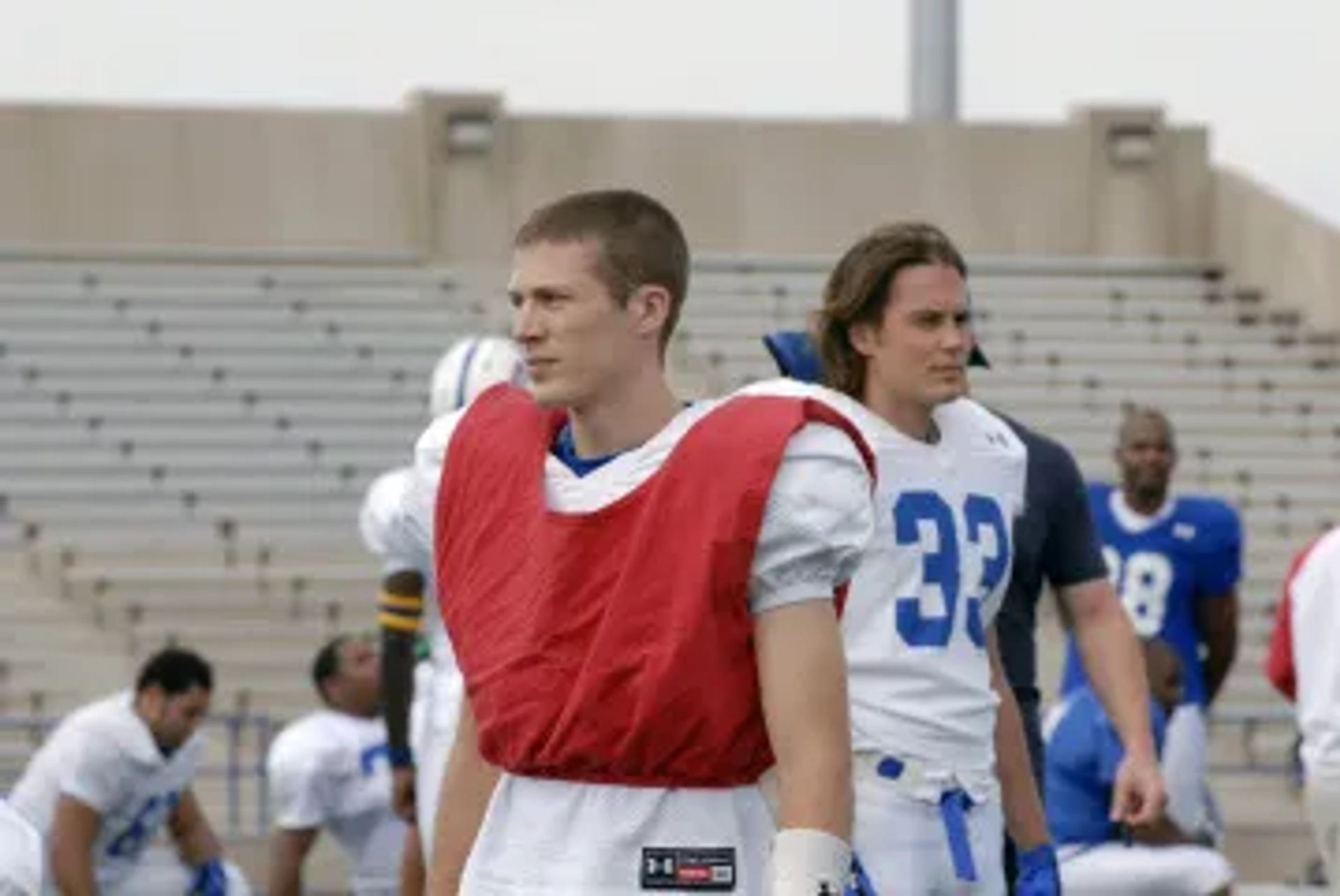 Zach Gilford and Taylor Kitsch in Friday Night Lights (2006)