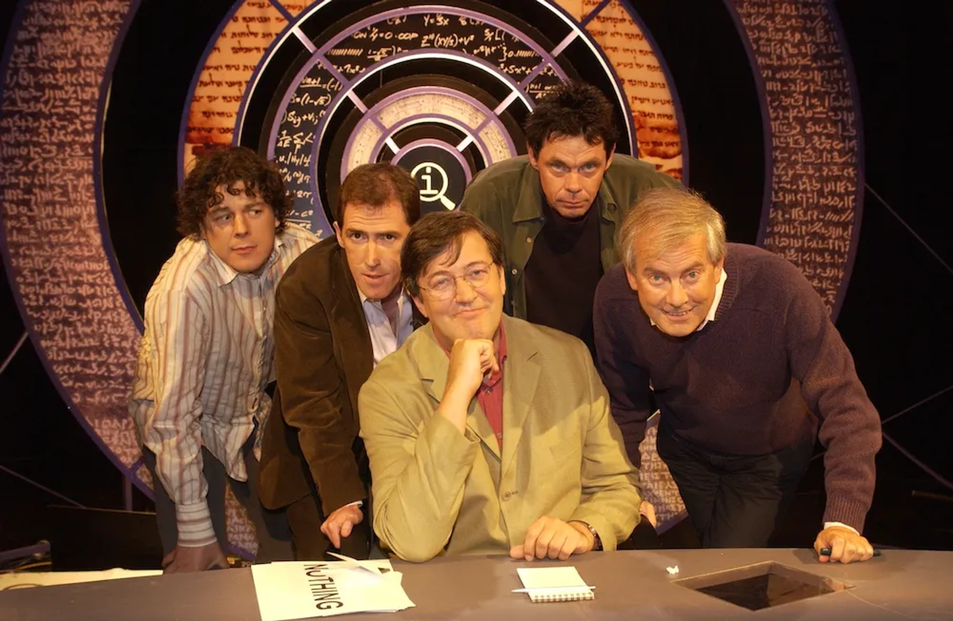 Stephen Fry, Rob Brydon, Alan Davies, Rich Hall, and Gyles Brandreth in QI (2003)