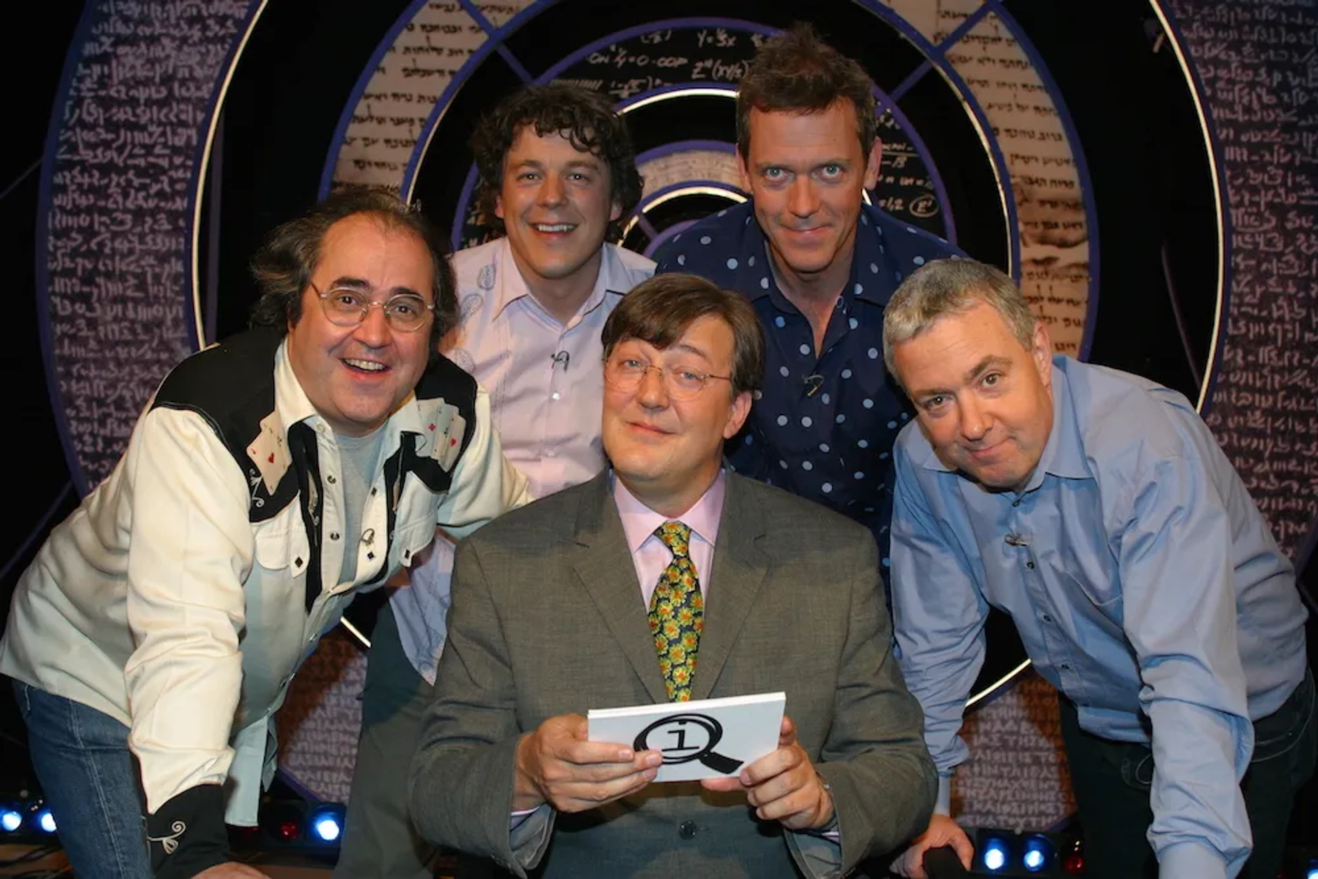 Stephen Fry, Danny Baker, Alan Davies, Hugh Laurie, and John Sessions in QI (2003)