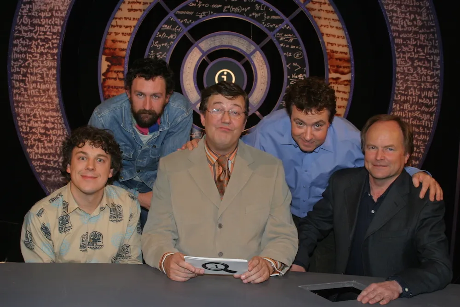 Stephen Fry, Clive Anderson, Alan Davies, Phil Kay, and John Sessions in QI (2003)