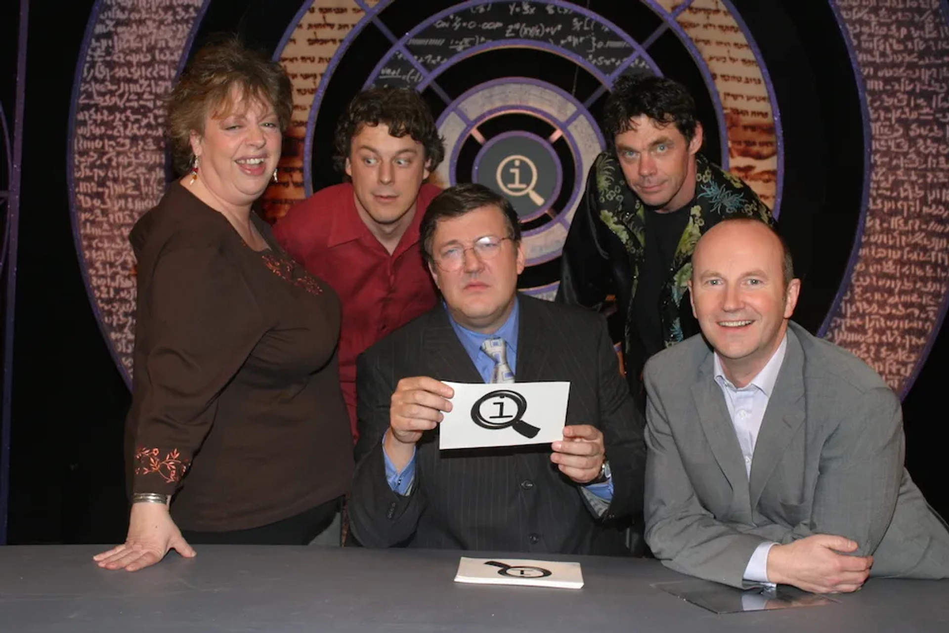 Stephen Fry, Jo Brand, Alan Davies, Rich Hall, and Fred MacAulay in QI (2003)