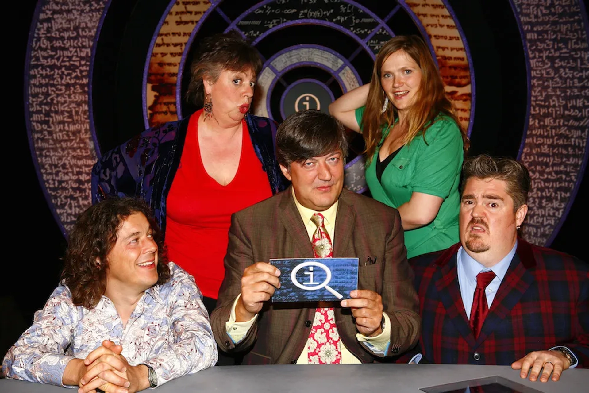 Stephen Fry, Jo Brand, Alan Davies, Phill Jupitus, and Jessica Hynes in QI (2003)