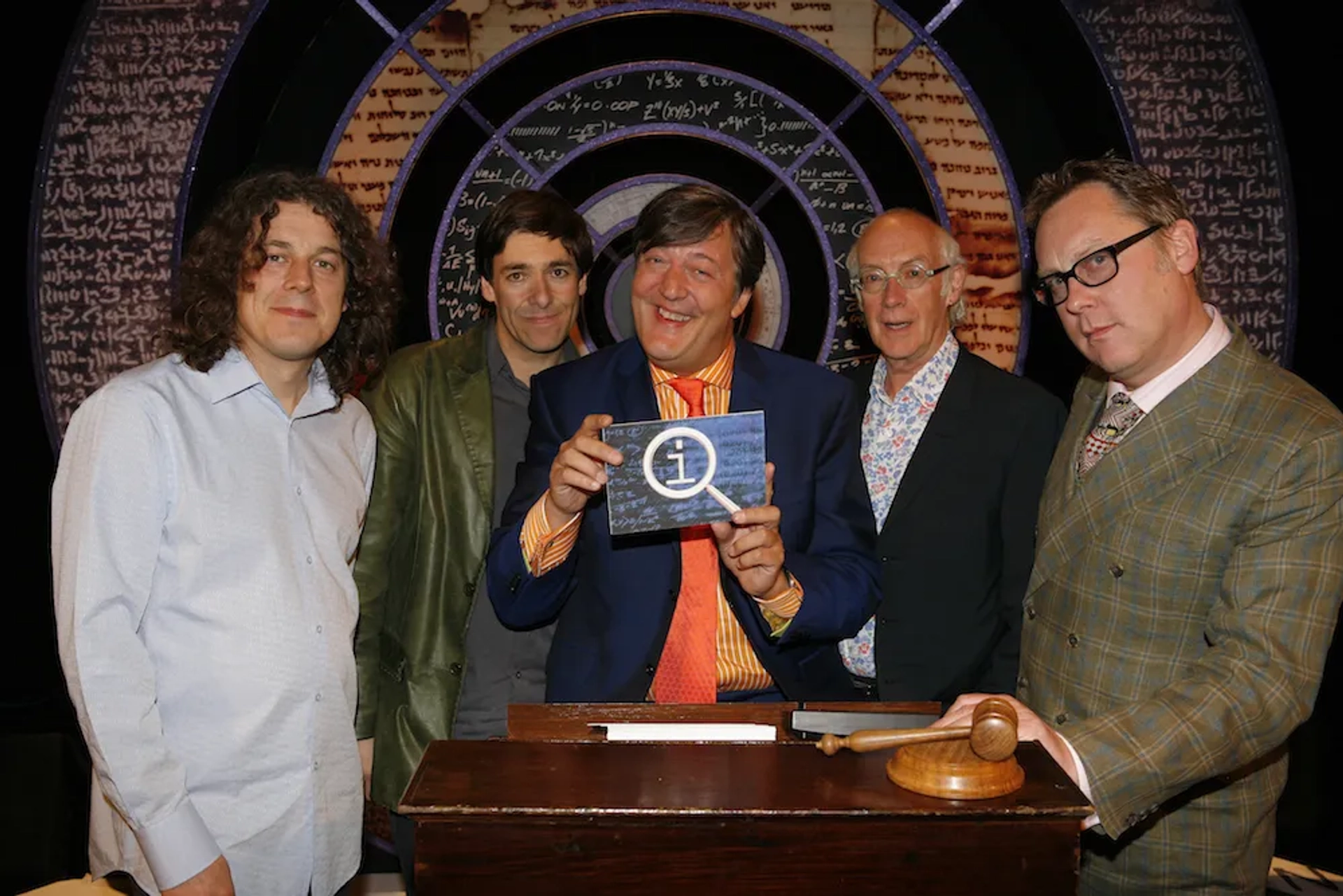 Stephen Fry, Alan Davies, Roger McGough, Vic Reeves, and Mark Steel in QI (2003)