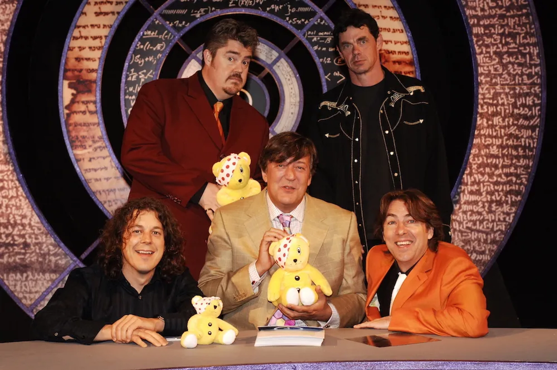 Stephen Fry, Alan Davies, Rich Hall, Phill Jupitus, and Jonathan Ross in QI (2003)