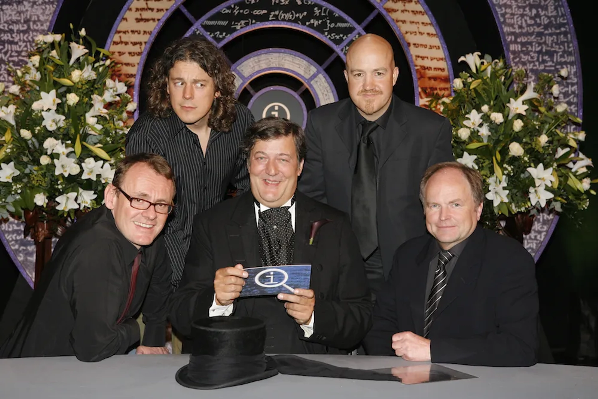 Stephen Fry, Clive Anderson, Alan Davies, Sean Lock, and Andy Parsons in QI (2003)