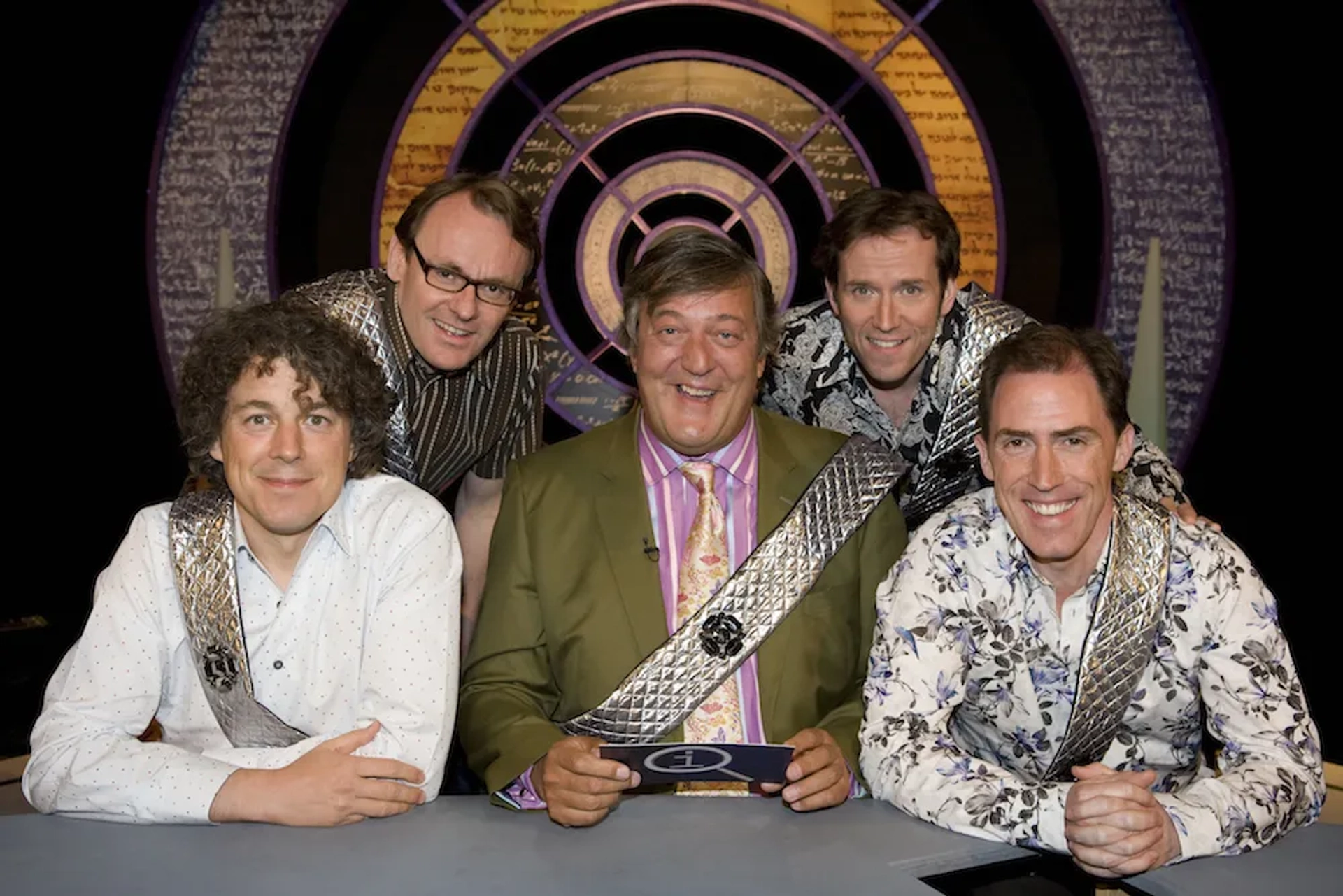 Stephen Fry, Rob Brydon, Alan Davies, Sean Lock, and Ben Miller in QI (2003)