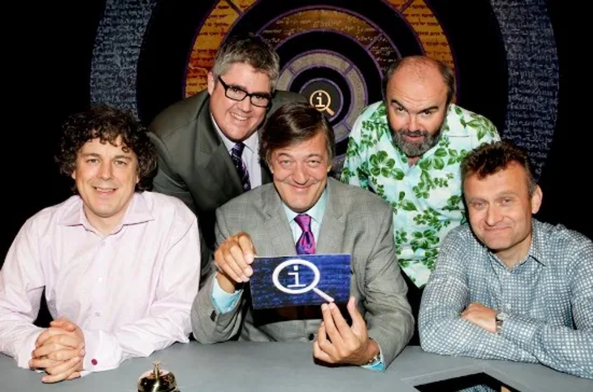 Stephen Fry, Alan Davies, Hugh Dennis, Andy Hamilton, and Phill Jupitus in QI (2003)