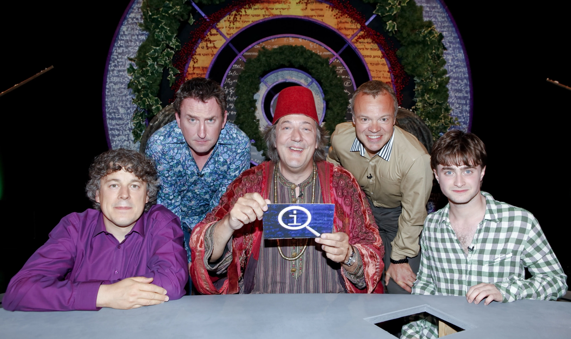 Stephen Fry, Alan Davies, Graham Norton, Daniel Radcliffe, and Lee Mack in QI (2003)