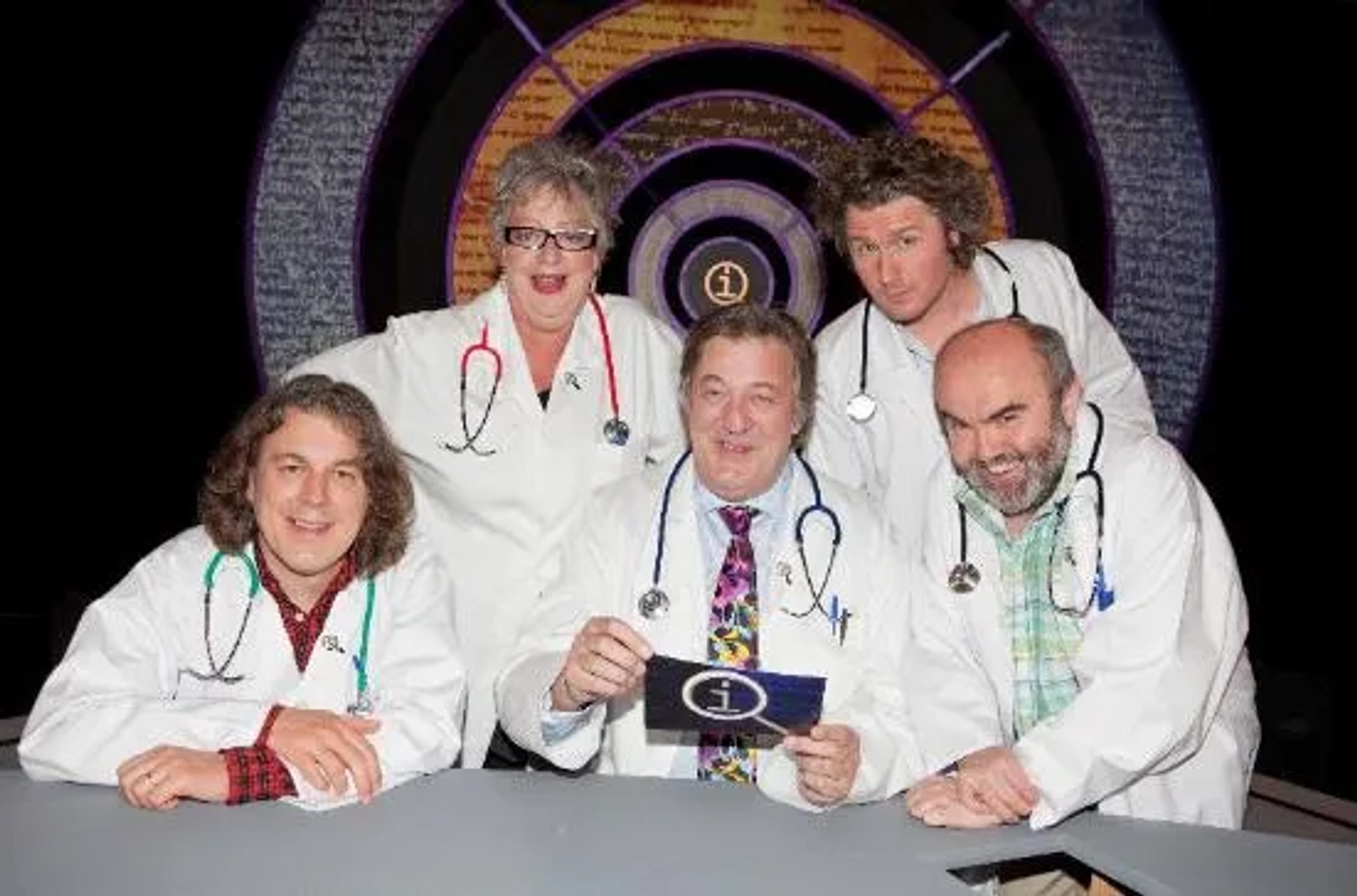 Stephen Fry, Jo Brand, Alan Davies, Andy Hamilton, and Ben Goldacre in QI (2003)