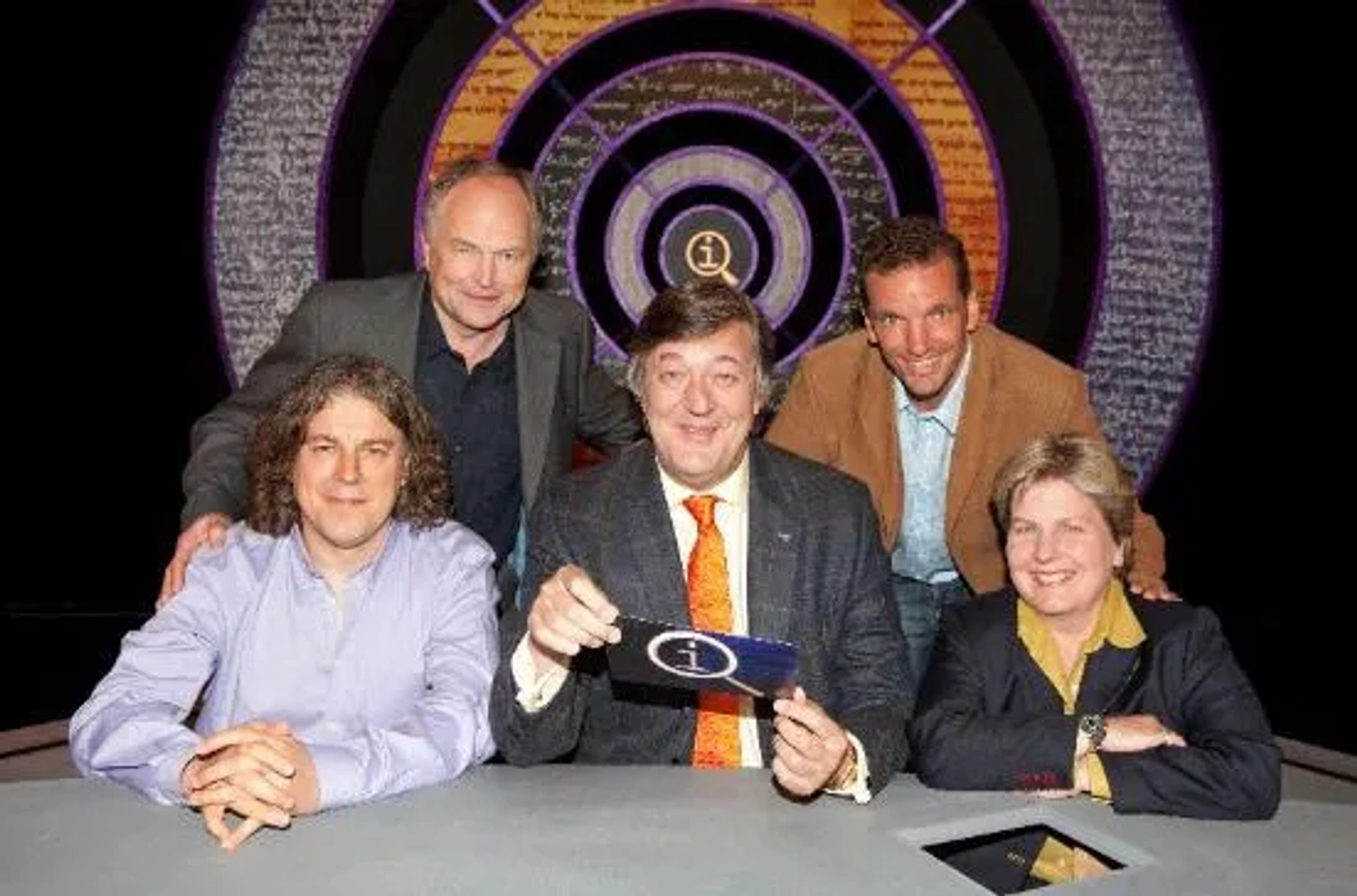 Stephen Fry, Clive Anderson, Alan Davies, Sandi Toksvig, and Henning Wehn in QI (2003)