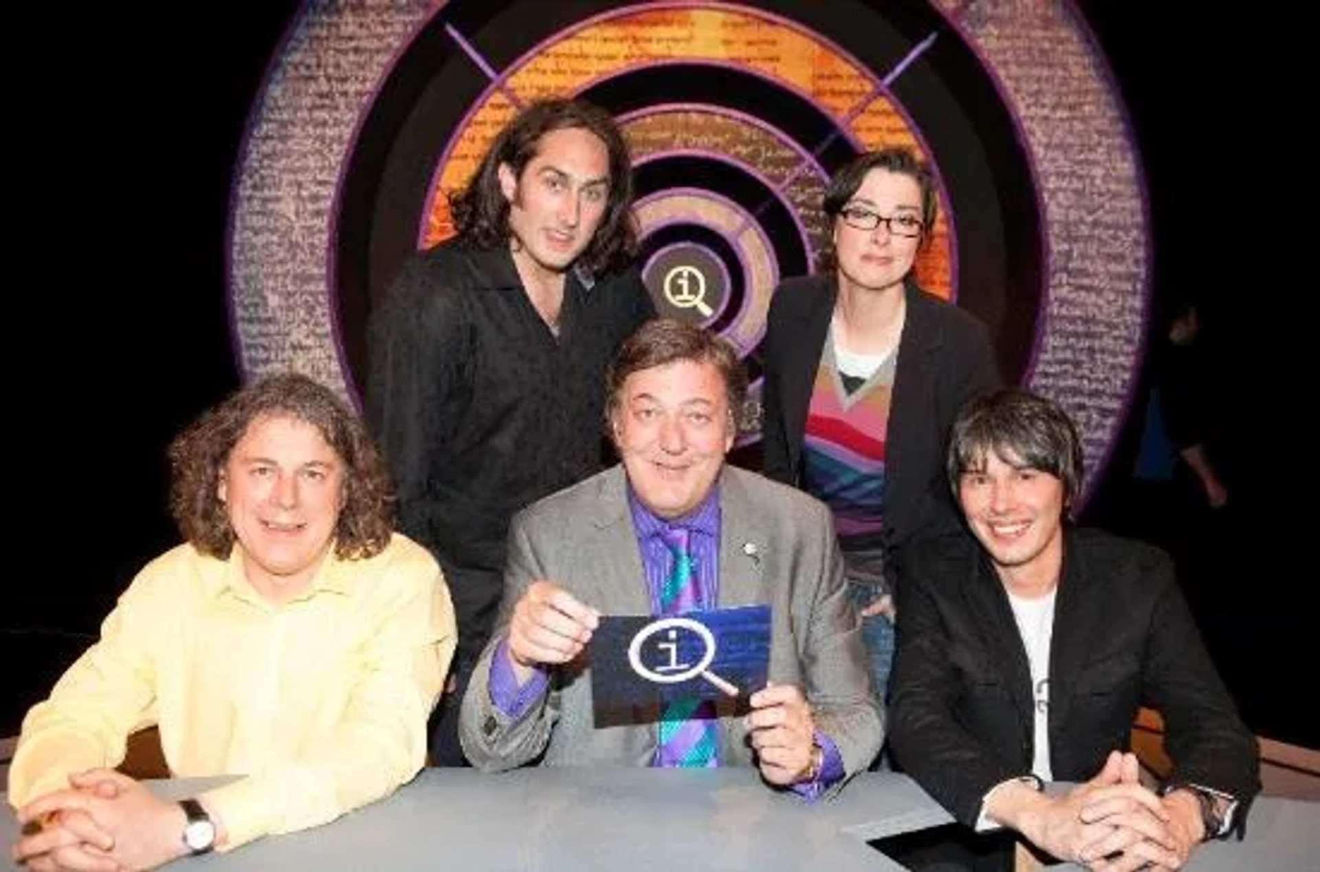 Stephen Fry, Alan Davies, Ross Noble, Sue Perkins, and Brian Cox in QI (2003)