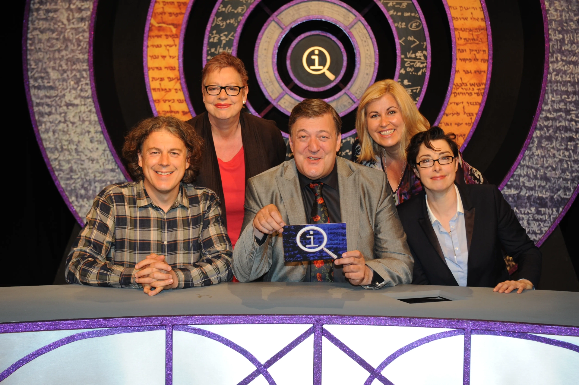 Stephen Fry, Jo Brand, Alan Davies, Sue Perkins, and Liza Tarbuck in QI (2003)