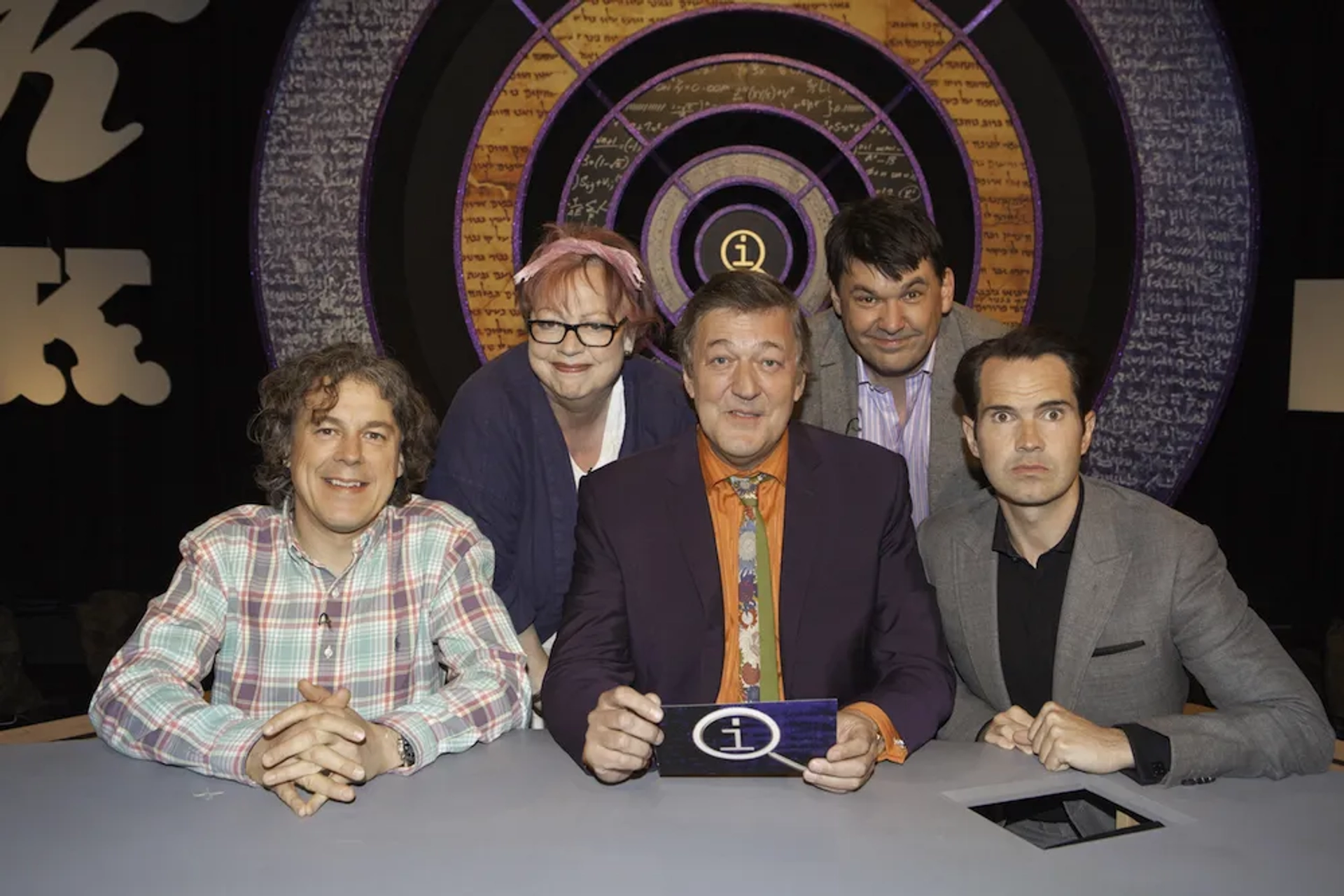 Stephen Fry, Jo Brand, Jimmy Carr, Alan Davies, and Graham Linehan in QI (2003)