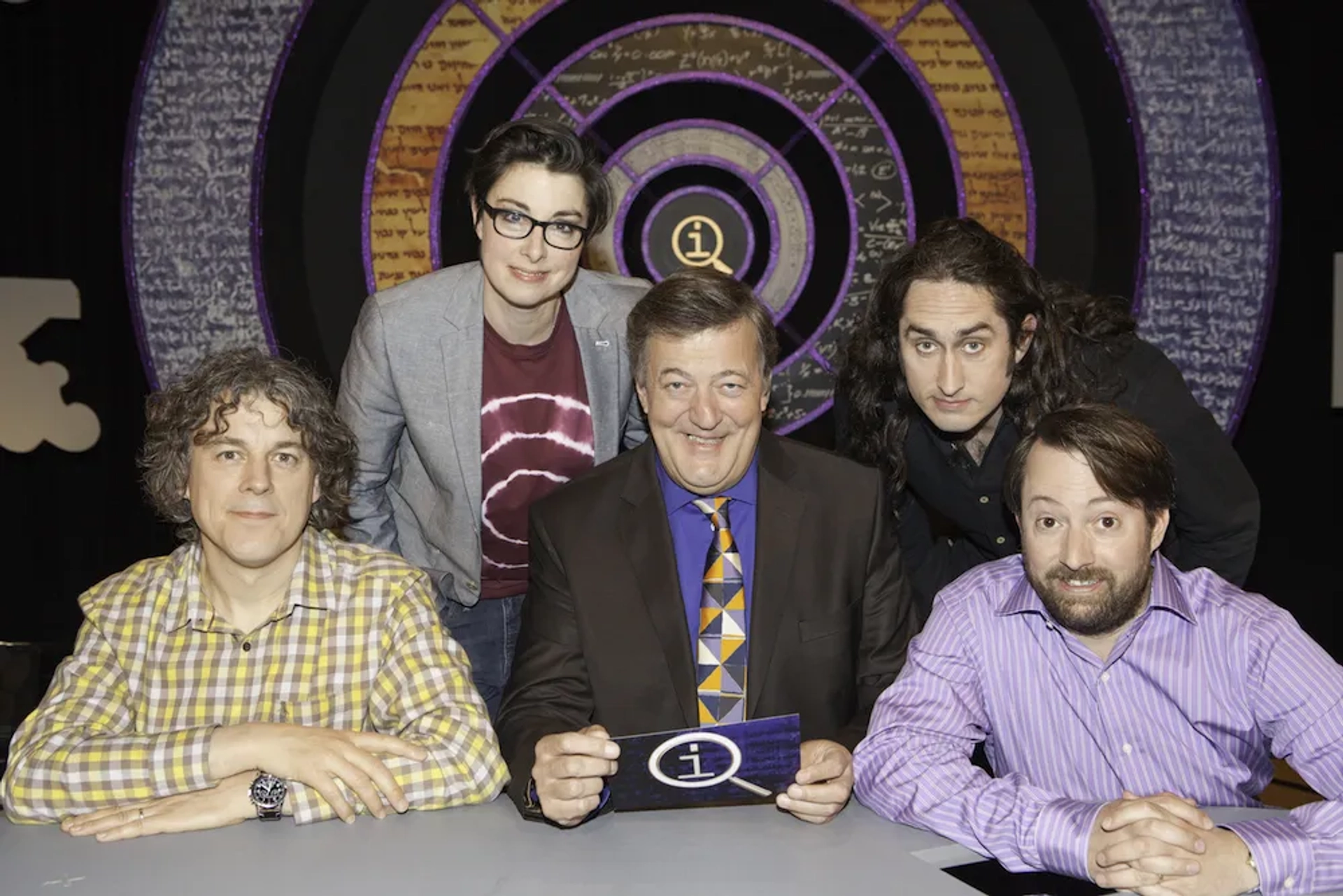 Stephen Fry, Alan Davies, David Mitchell, Ross Noble, and Sue Perkins in QI (2003)