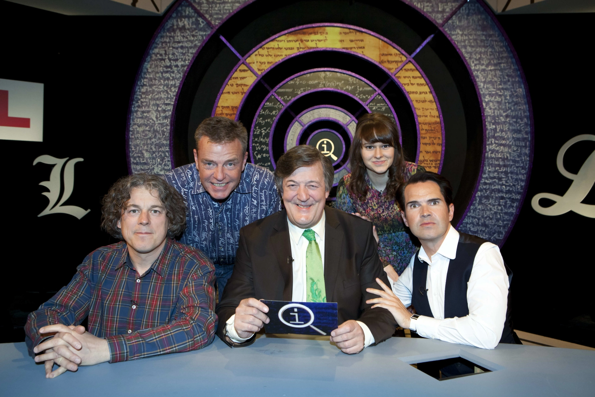 Stephen Fry, Jimmy Carr, Alan Davies, Suggs, and Claudia O'Doherty in QI (2003)