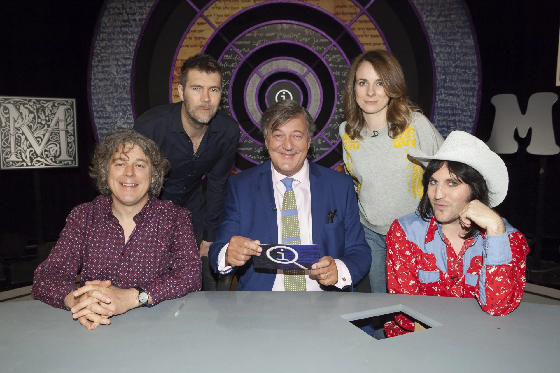 Stephen Fry, Alan Davies, Noel Fielding, Rhod Gilbert, and Cariad Lloyd in QI (2003)