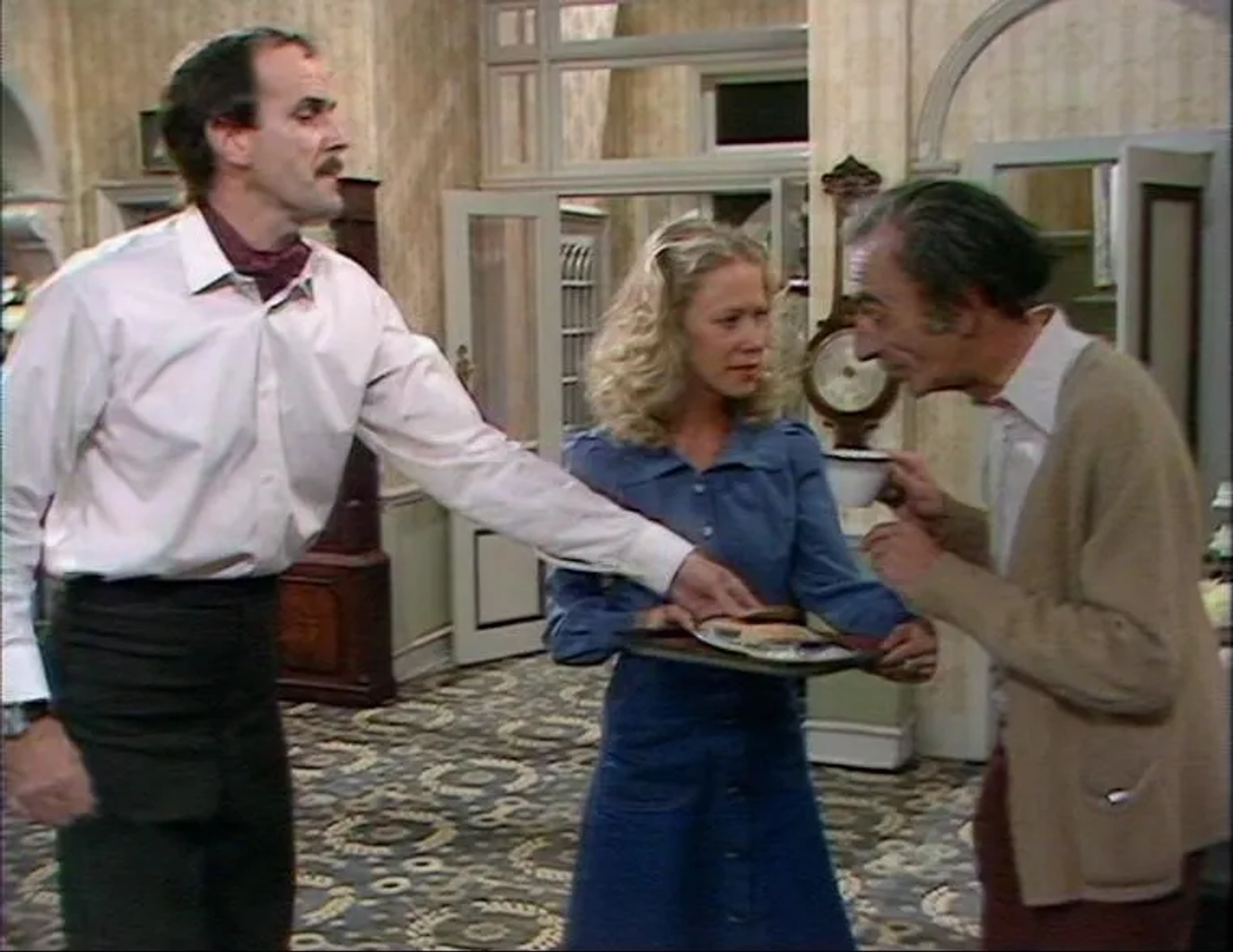 John Cleese, Connie Booth, and David Kelly in Fawlty Towers (1975)