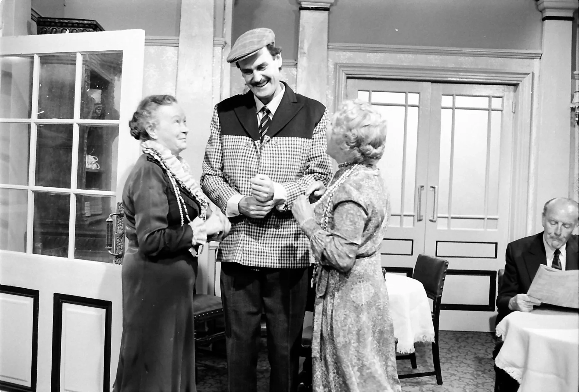 John Cleese, Gilly Flower, and Renee Roberts in Fawlty Towers (1975)