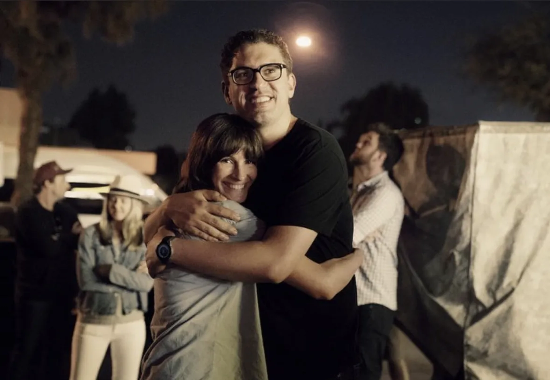 Julia Roberts and Sam Esmail embrace after wrapping season 1 of "Homecoming". In background, left to right, Daniel Dawson (asst. location manager), Michelle Lankwarden (UPM), and Chad Peter (VFX Supervisor).