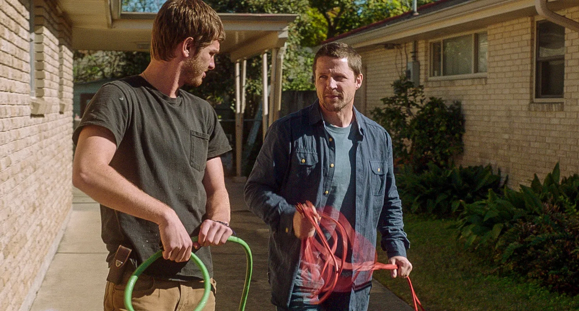 Tim Guinee and Andrew Garfield in 99 Homes (2014)