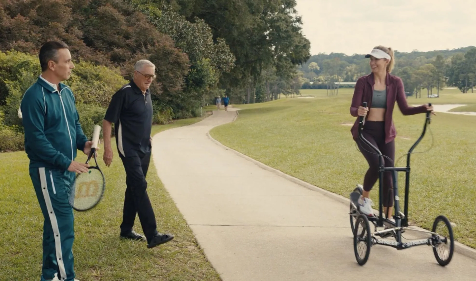 overly cheerful Laura Ault riding elliptical bike