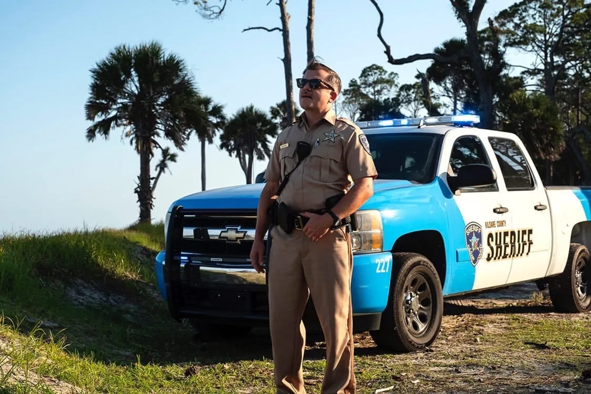 Belts are handy hand rests, as demonstrated by Cullen Moss, as Deputy Victor Shoupe, on Outer Banks.