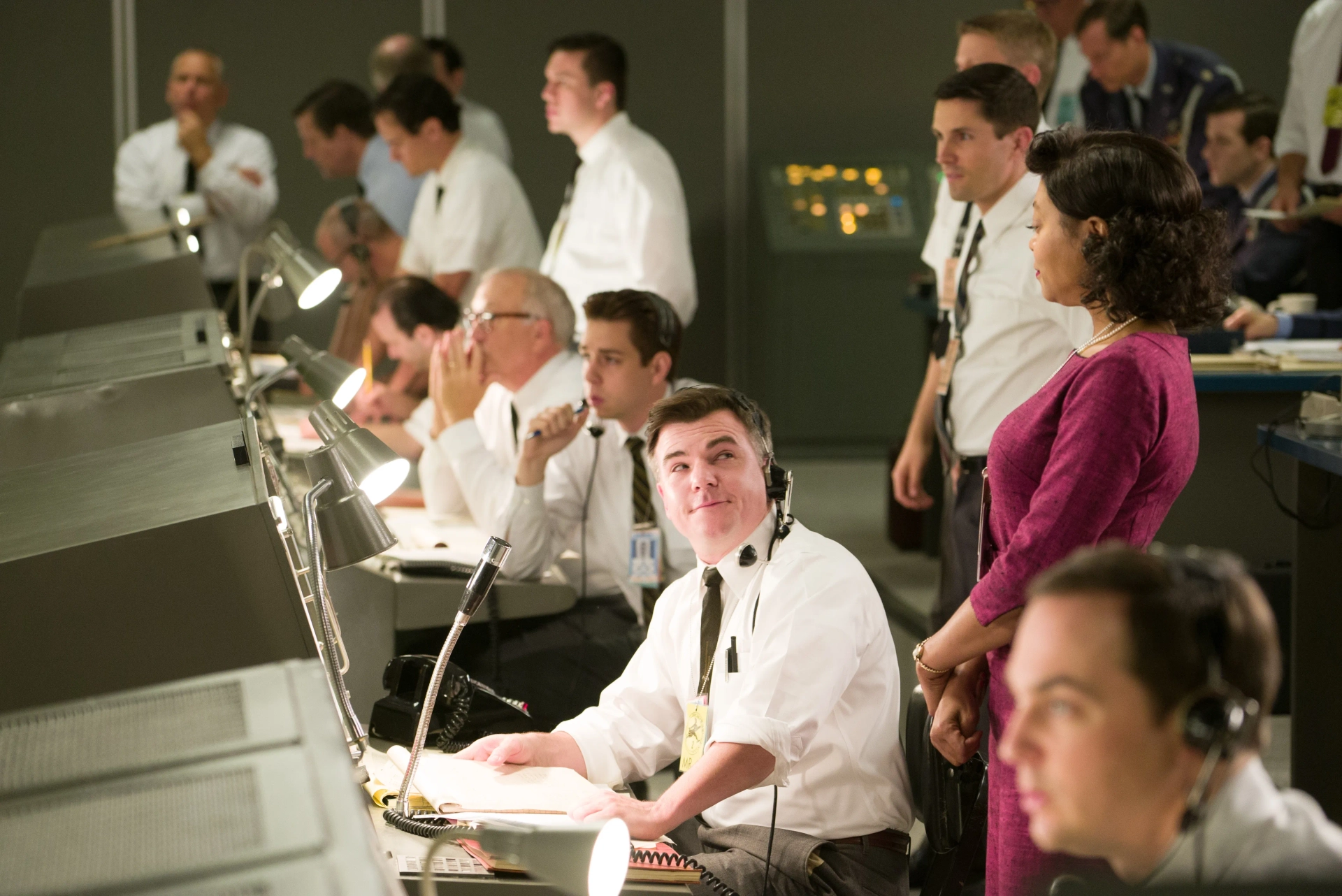 Mission Control (Cullen Moss) receives assuring information from Katherine Johnson (Taraji Henson). With Kurt Krause, Evan Holtzman, Taraji Henson, and Jim Parsons.