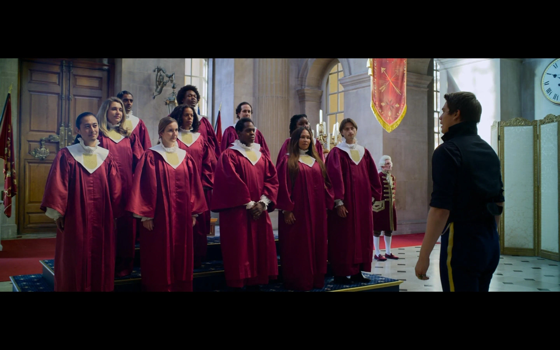 Sanj singing as part of the choir with Nicholas Galitzine in Cinderella 2021