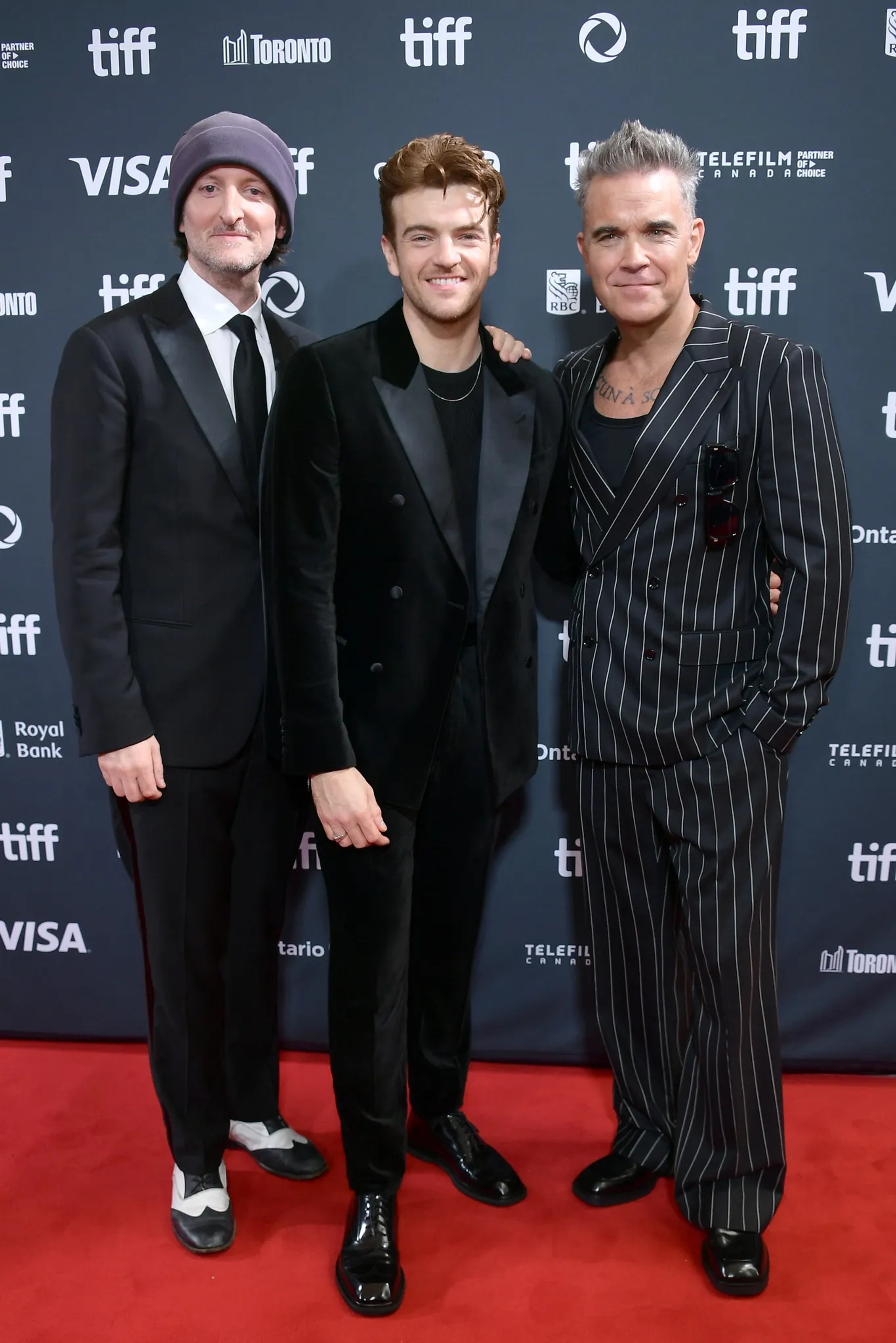 Robbie Williams, Michael Gracey, and Jonno Davies at an event for Better Man (2024)