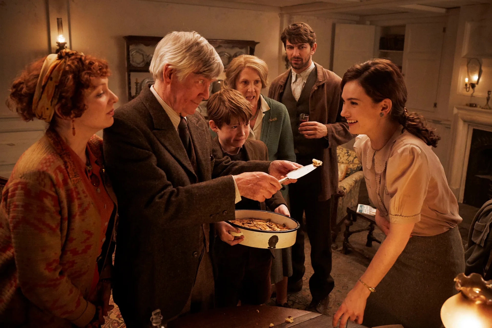 Tom Courtenay, Michiel Huisman, Penelope Wilton, Katherine Parkinson, Lily James, and Kit Connor in The Guernsey Literary and Potato Peel Pie Society (2018)