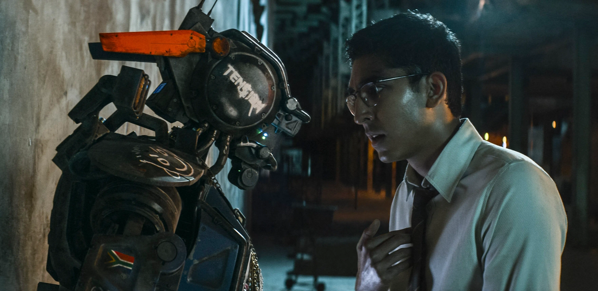 Sharlto Copley and Dev Patel in Chappie (2015)