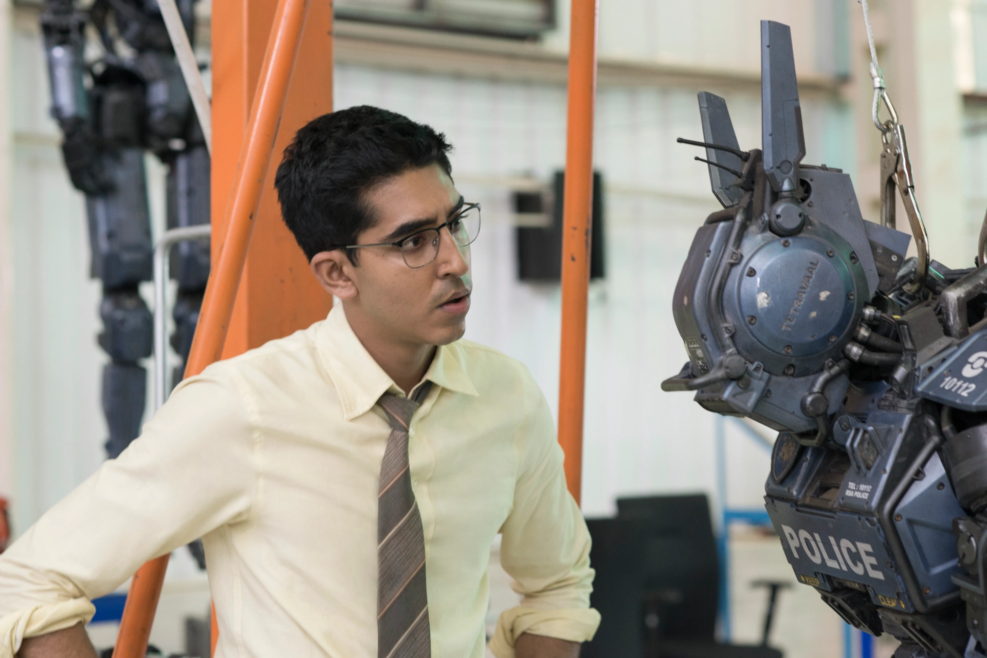 Sharlto Copley and Dev Patel in Chappie (2015)