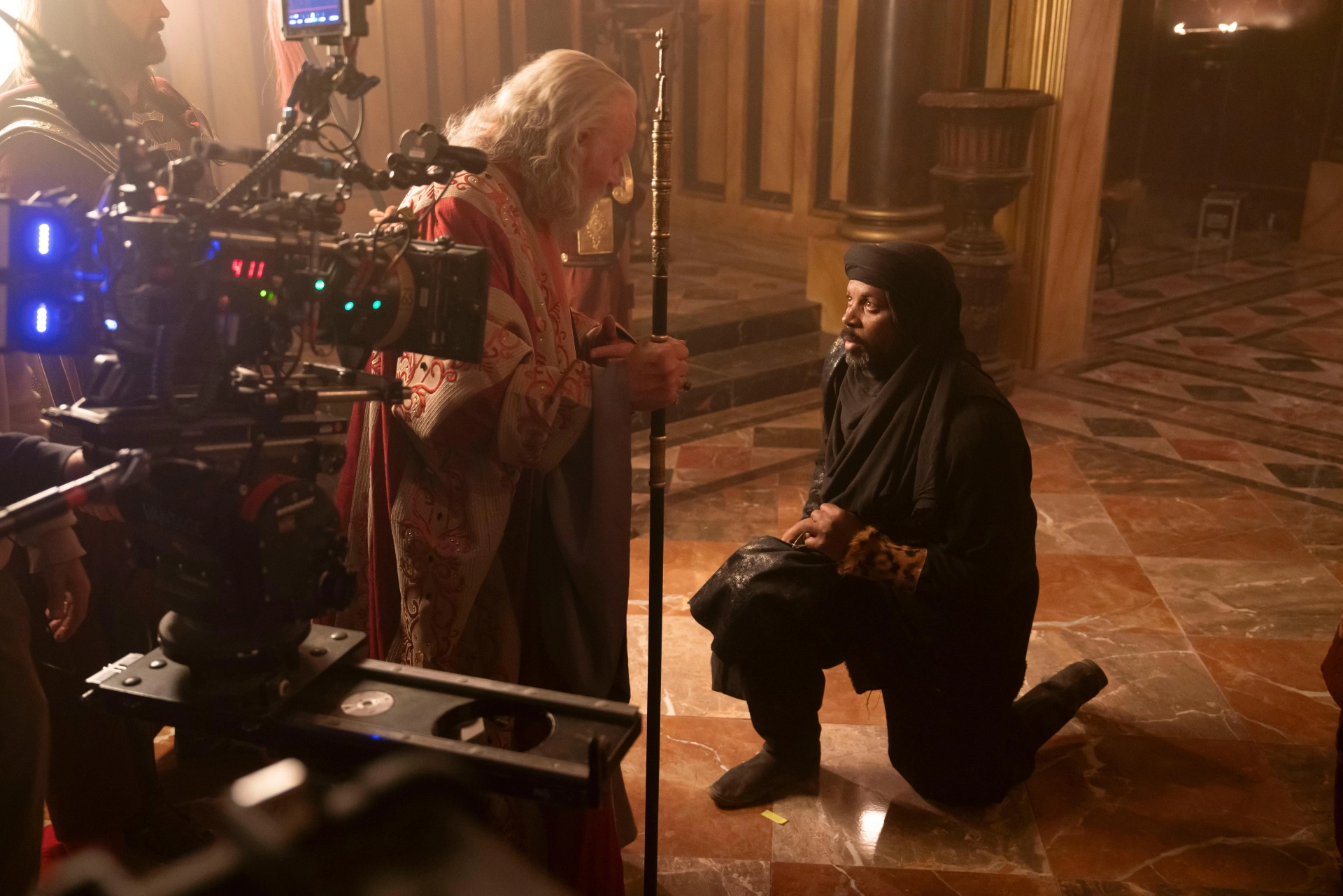 VIHAAN (Kamal Moummad) kneeling before KING HEROD (Sir. Anthony Hopkins) in MARY; written by Timothy Michael Hayes. Directed by D.J. Caruso. Produced by Mary Aloe, Hannah Leader, and Amory Leader. MARY is now streaming on NETFLIX.