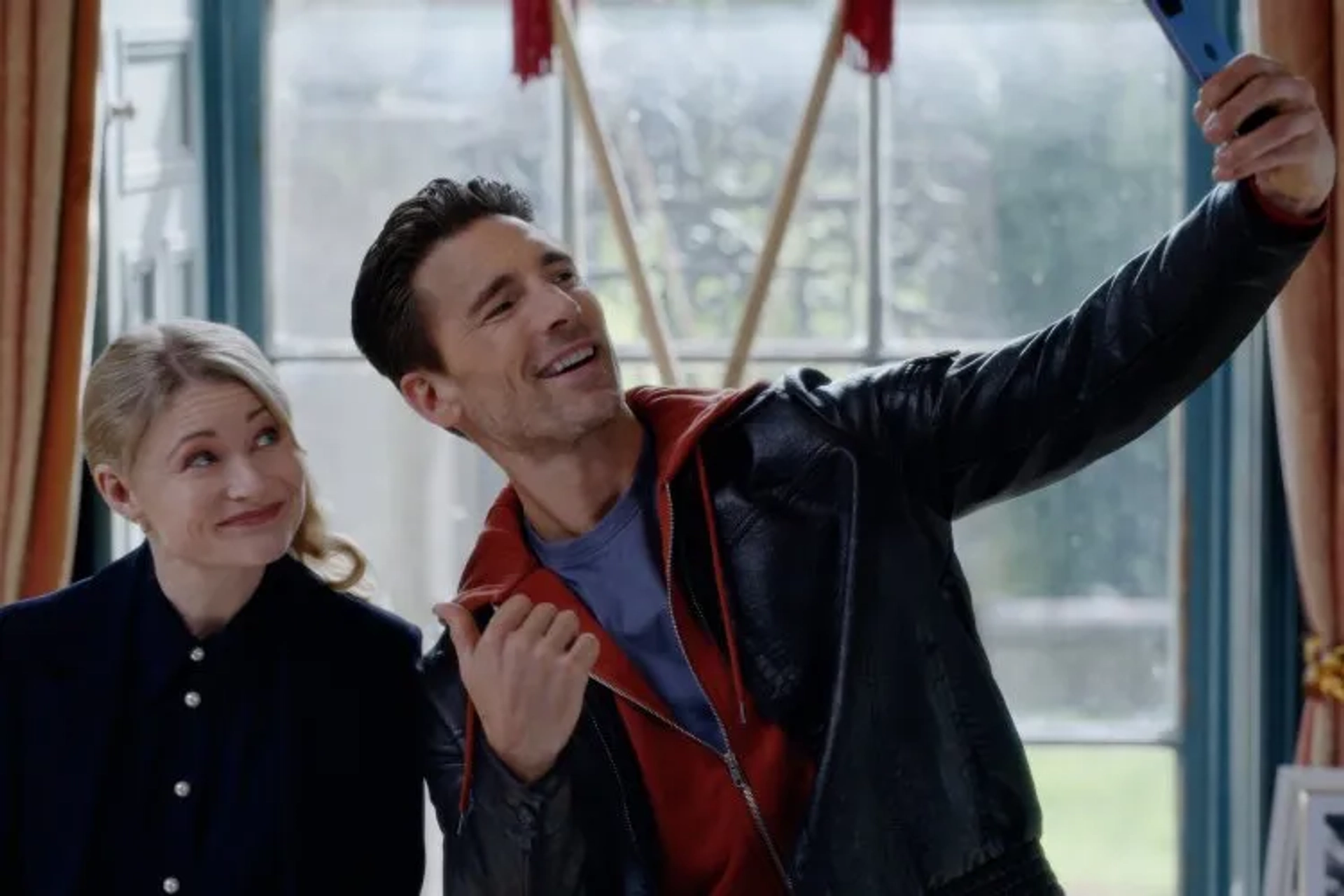 Emilie de Ravin and Andrew W. Walker in The Reluctant Royal (2025)